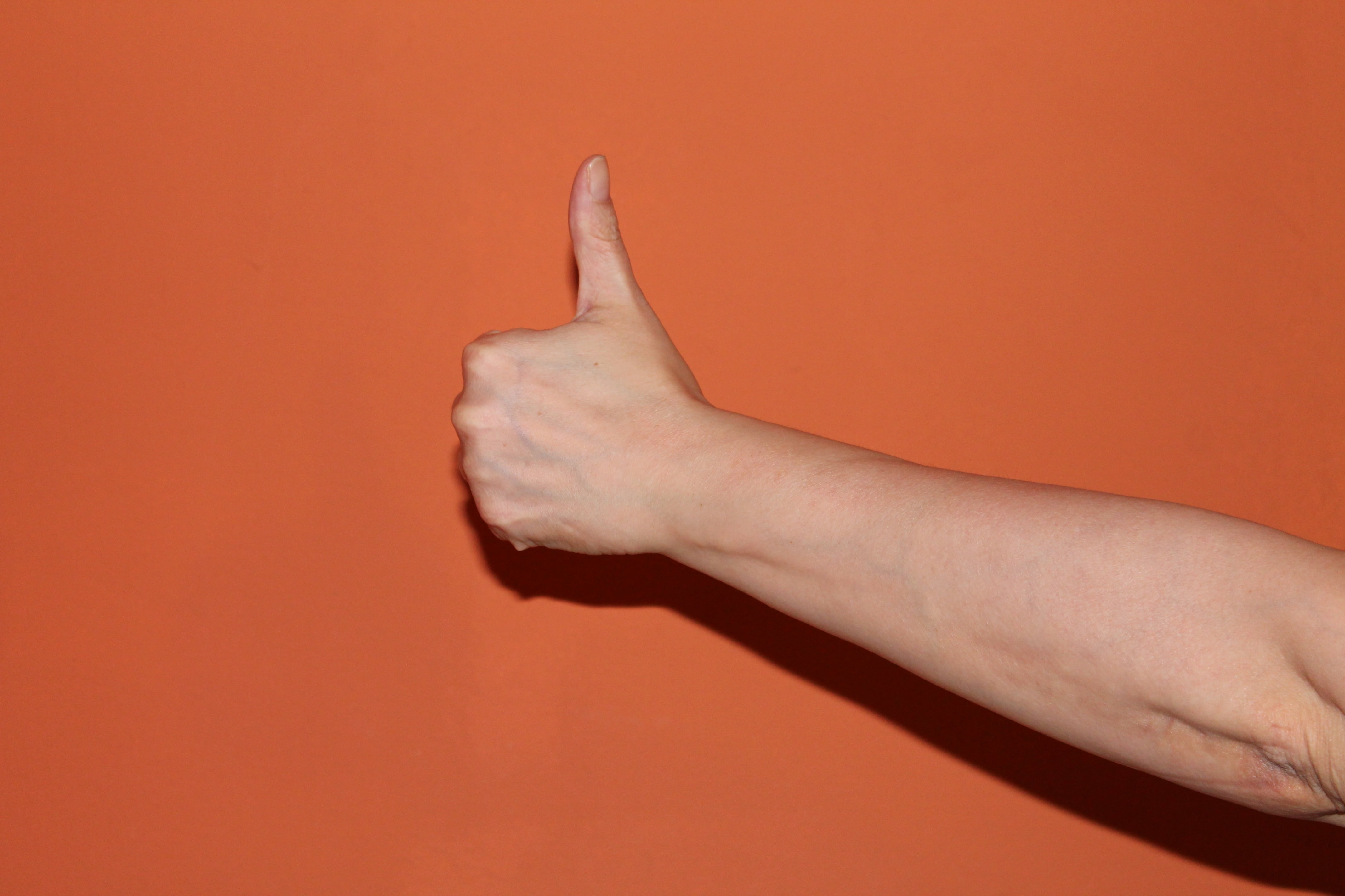one person, thumb, indoors, approve, studio shot, finger, hand, close-up, red, people, body part, orange background, gesturing, human body part, colored background, HD Wallpaper