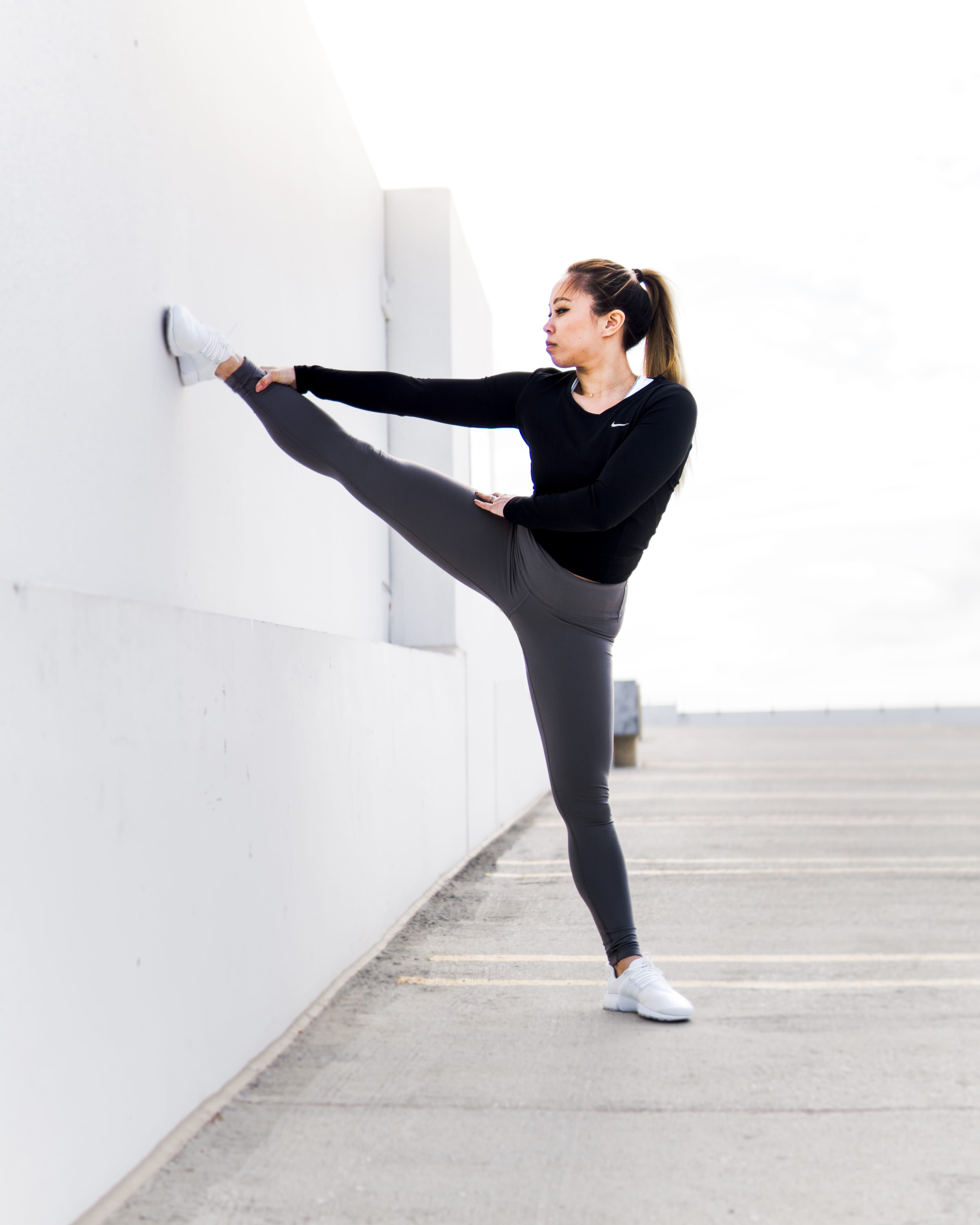balance, white, standing, wall, beautiful woman, young women, flex, arms raised, sport, exercising, right, warmup, looking, woman, exercise, leggings, felxible, Phone HD Wallpaper