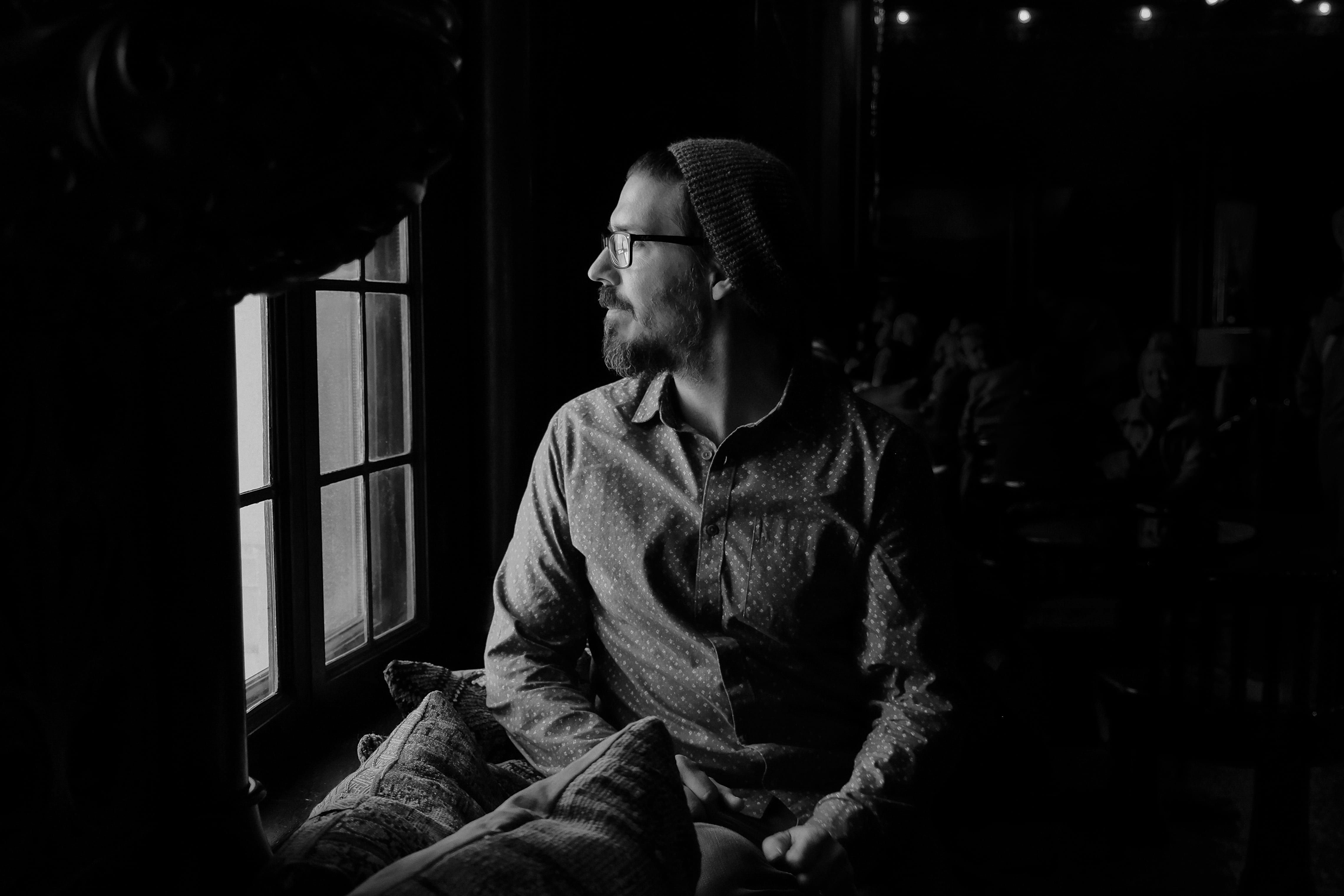 black And White, adult, greyscale, window, photo, home interior, man, indoors, mid adult men, photography, adults only, sadness, glass, male, outside, warm clothing, HD Wallpaper