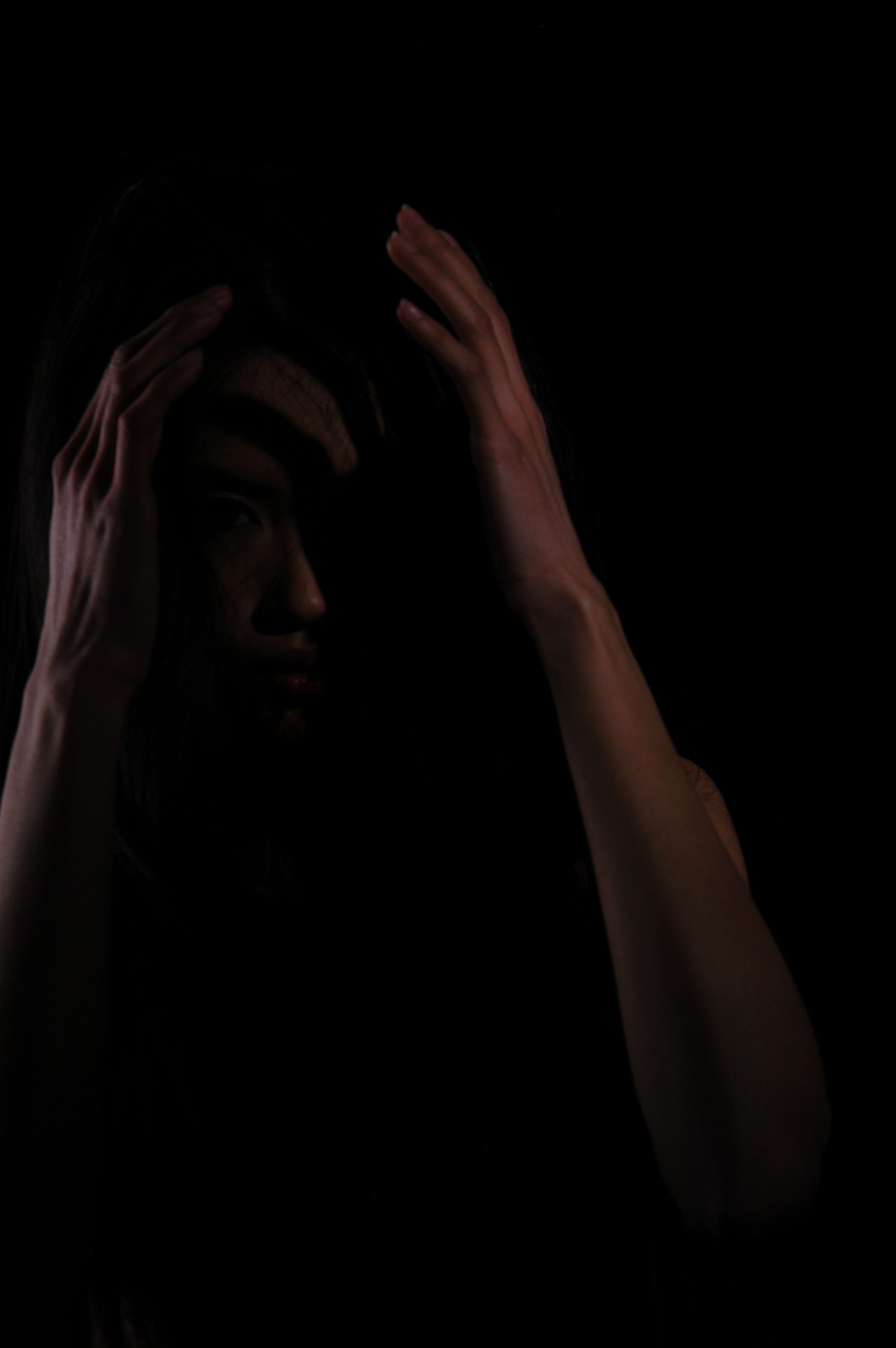 arms raised, women, black background, depression - sadness, human body part, mid adult, young woman, contemplation, mysterious, indoors, dark, human face, Phone HD Wallpaper