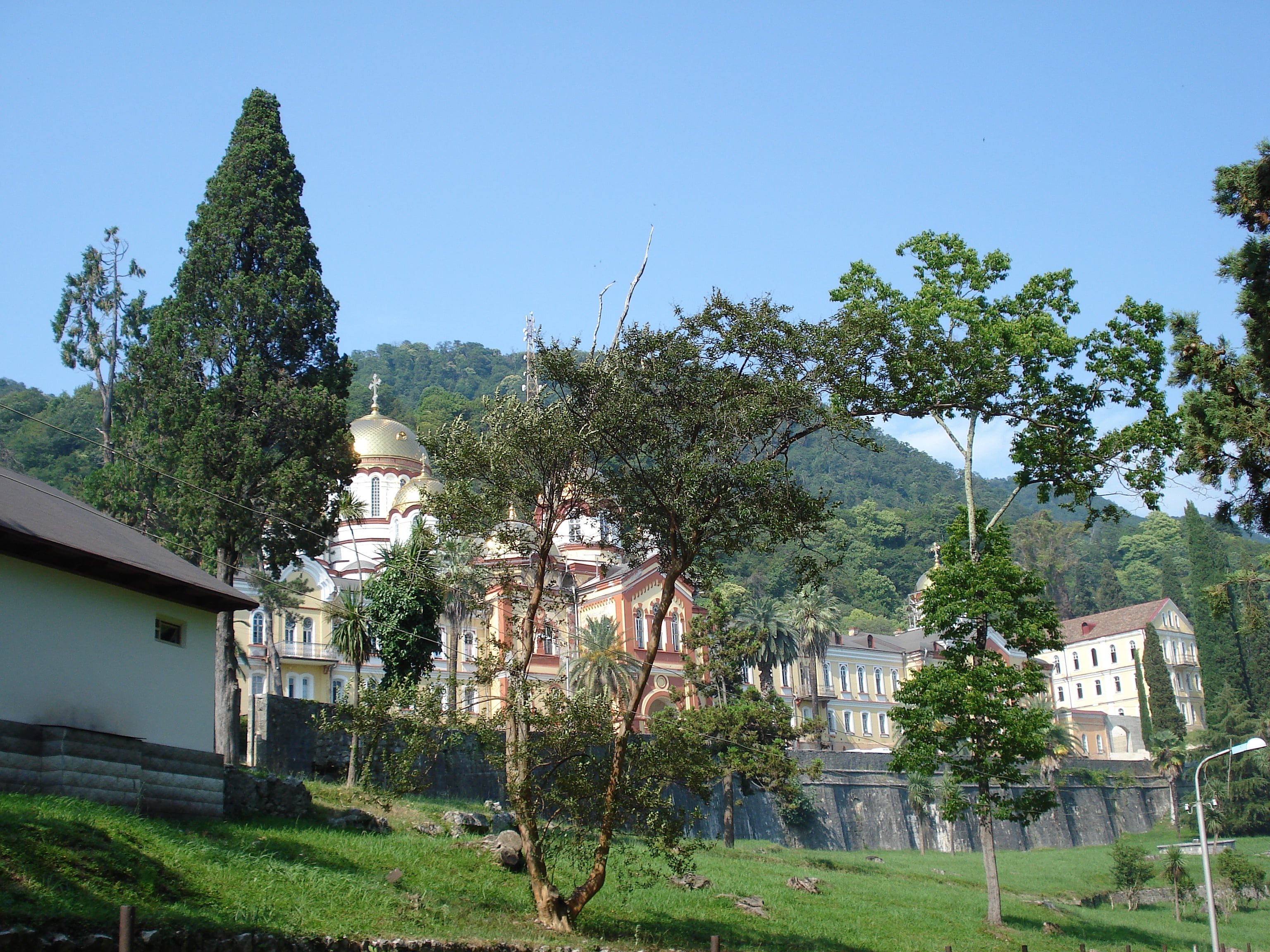 outdoors, grass, new athos, growth, green color, tress, famous Place, house, building Exterior, history, 2K, no people, tree, old, athos monastery, town, HD Wallpaper