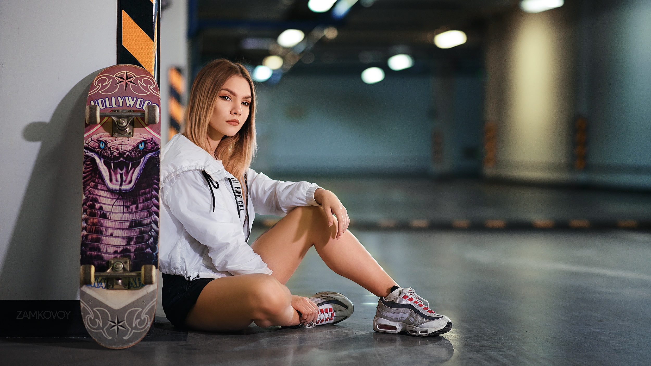women indoors, model, on the floor, white jacket, portrait, depth of field, parking lot, women, looking at viewer, 1080P, skateboard, jean shorts, bokeh, HD Wallpaper