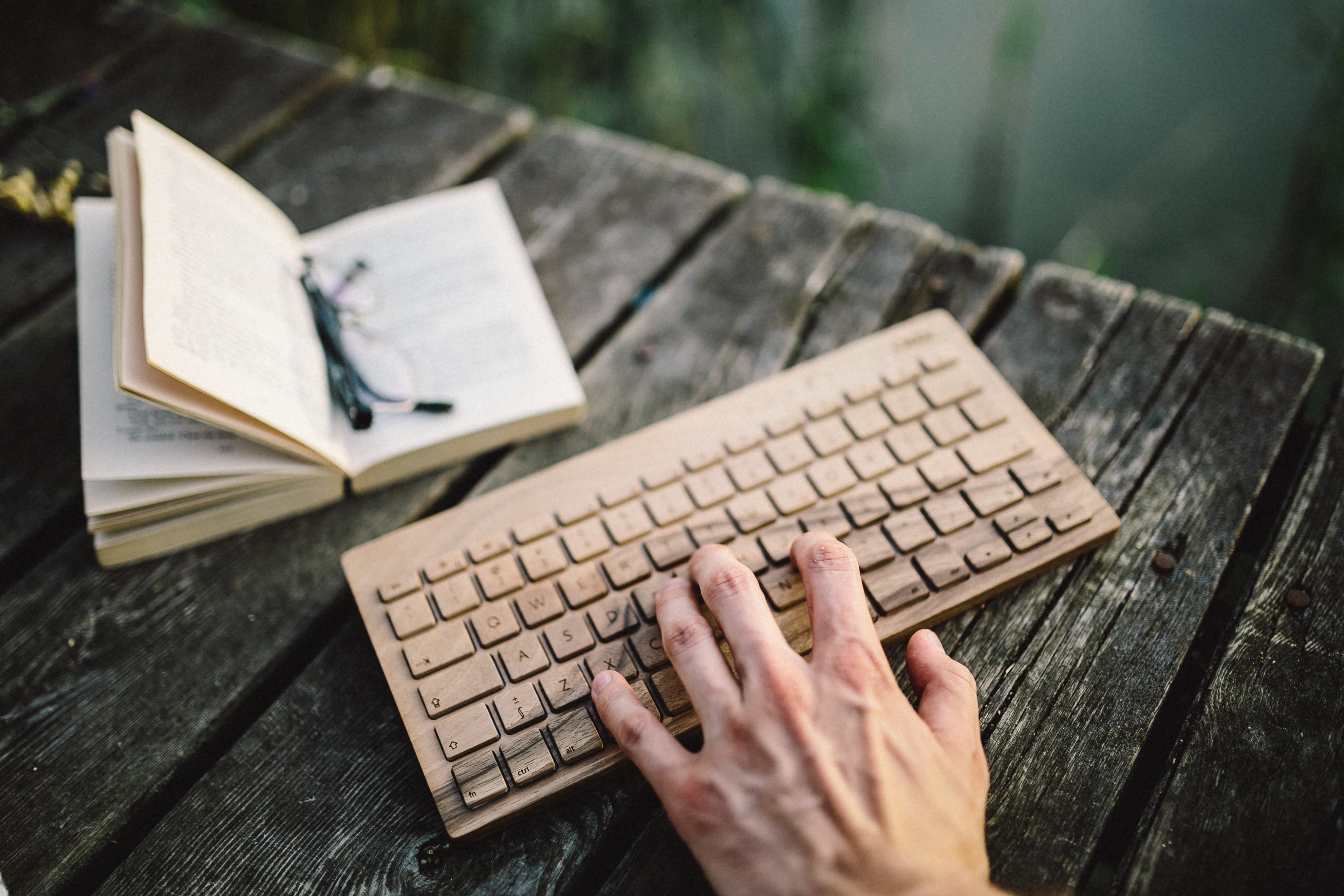 Male, outdoors, hand, table, 4K, communication, wooden keyboard, wooden, leisure activity, book, opened book, oree, business, high angle view, typing, HD Wallpaper