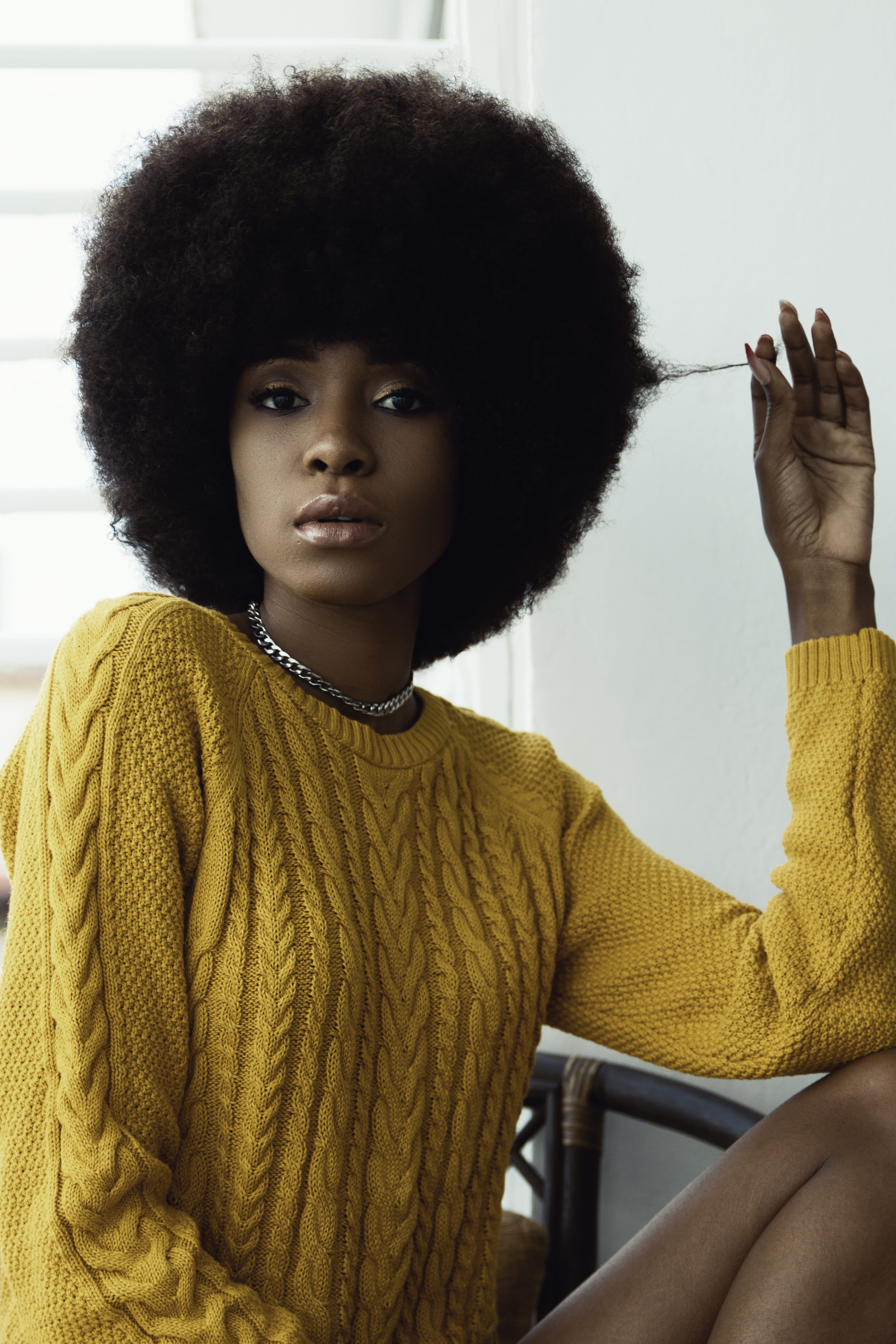 yellow, indoors, portrait, young women, selective, real people, waist up, warm clothing, headshot, focus, holding, afro, sweater, lifestyles, looking at camera, Phone HD Wallpaper