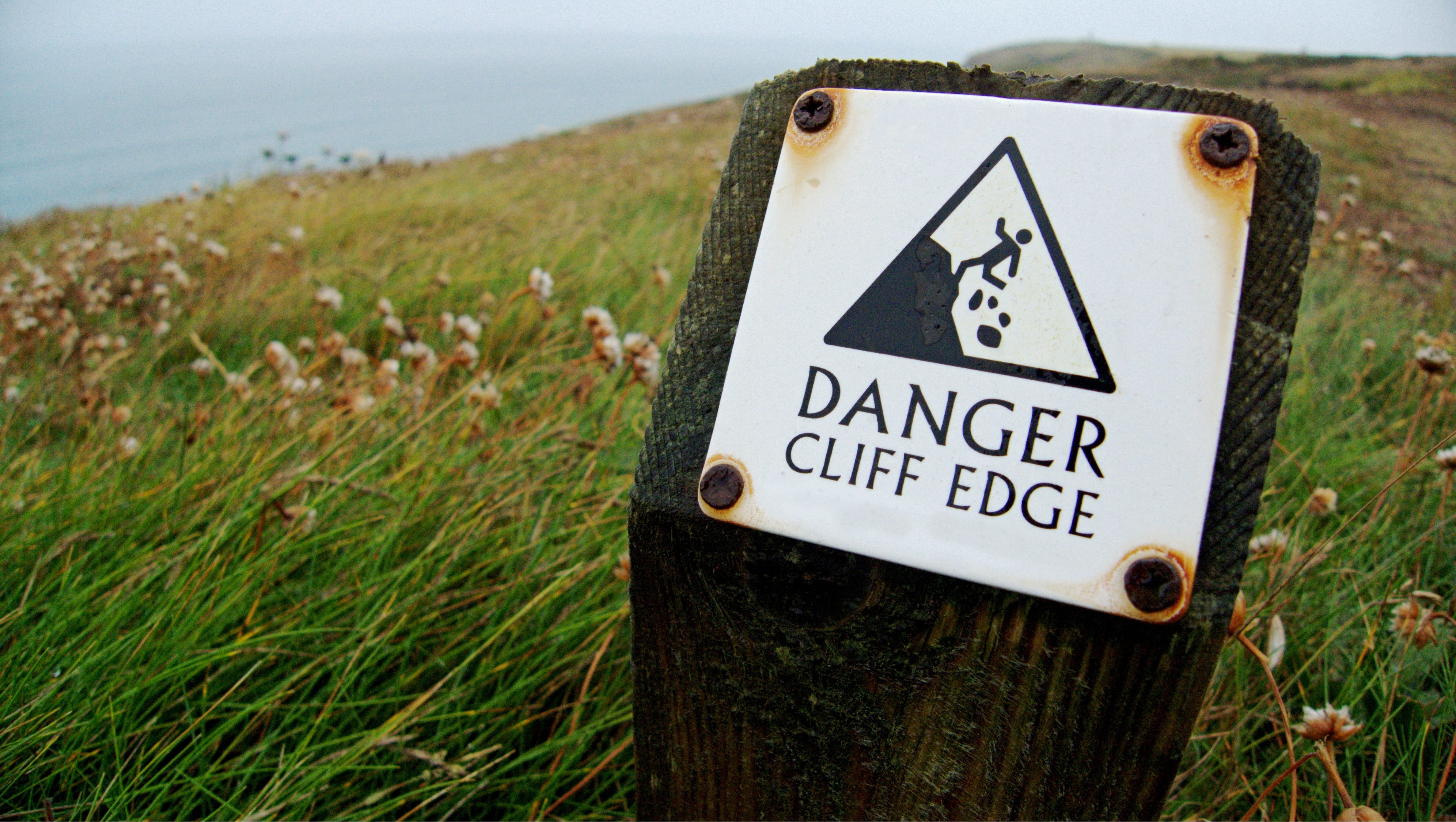 adrenaline, warning sign, Risk, text, water, western script, information sign, signage, day, grass, cliff, 4K, metal, green color, outdoors, close-up, HD Wallpaper
