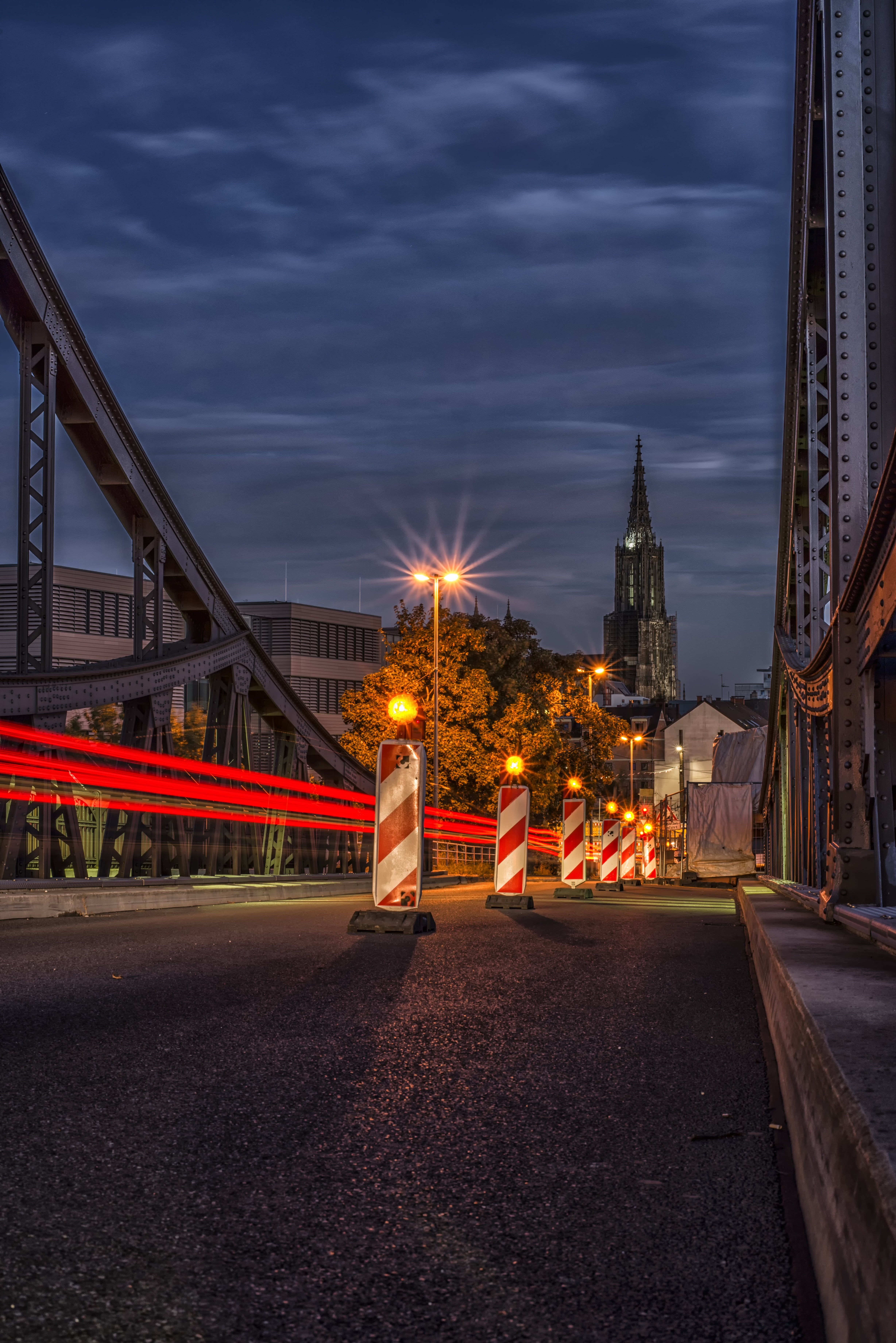 built structure, sky, motion, city, nature, dark, lamps, mode of transportation, bridge, steeple, connection, cloud - sky, lighting, road, surface level, Phone HD Wallpaper