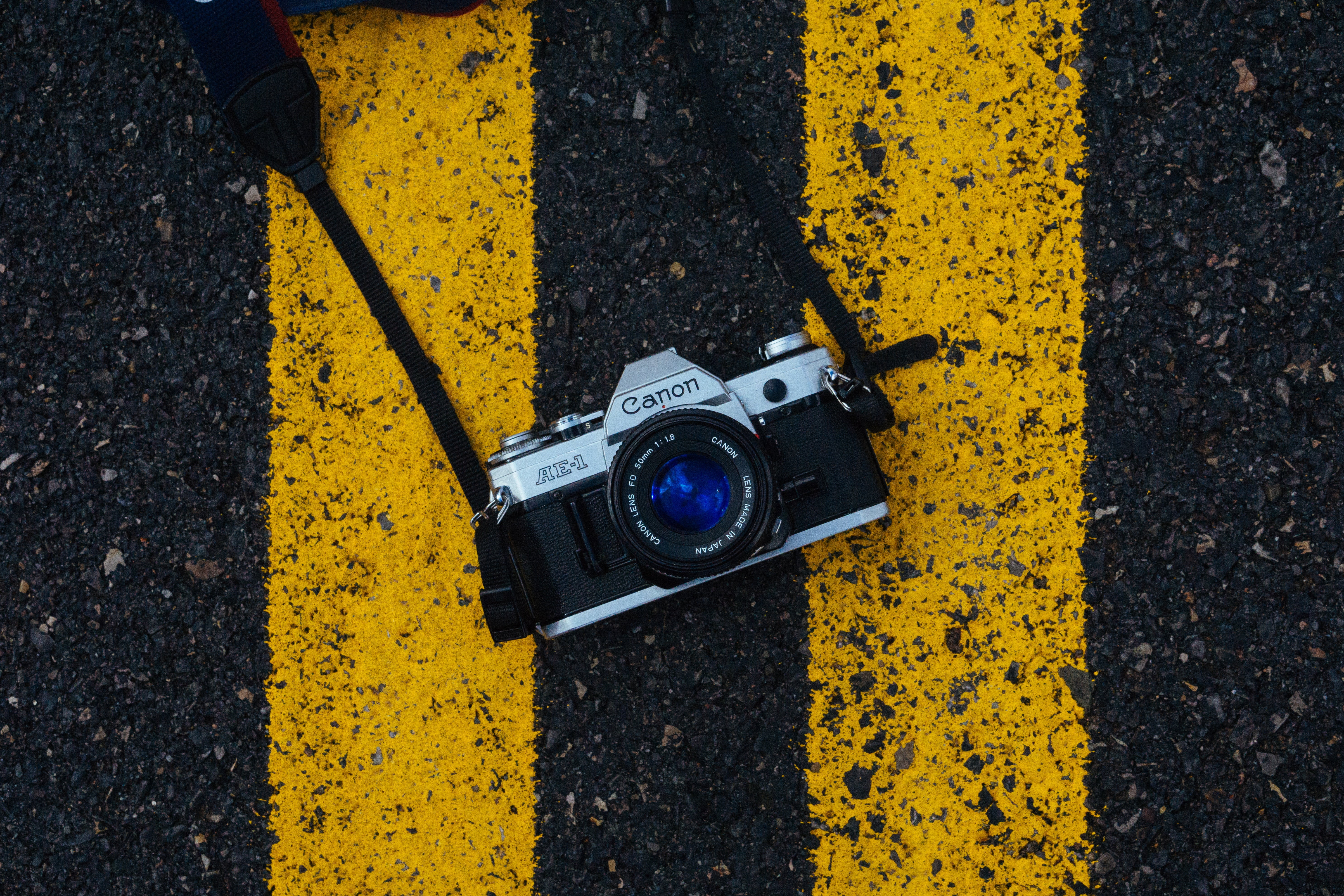 slr camera, camera, outdoors, one person, road, road marking, technology, symbol, yellow, nature, city, asphalt, marking, digital camera, 5K, markup, transportation, HD Wallpaper