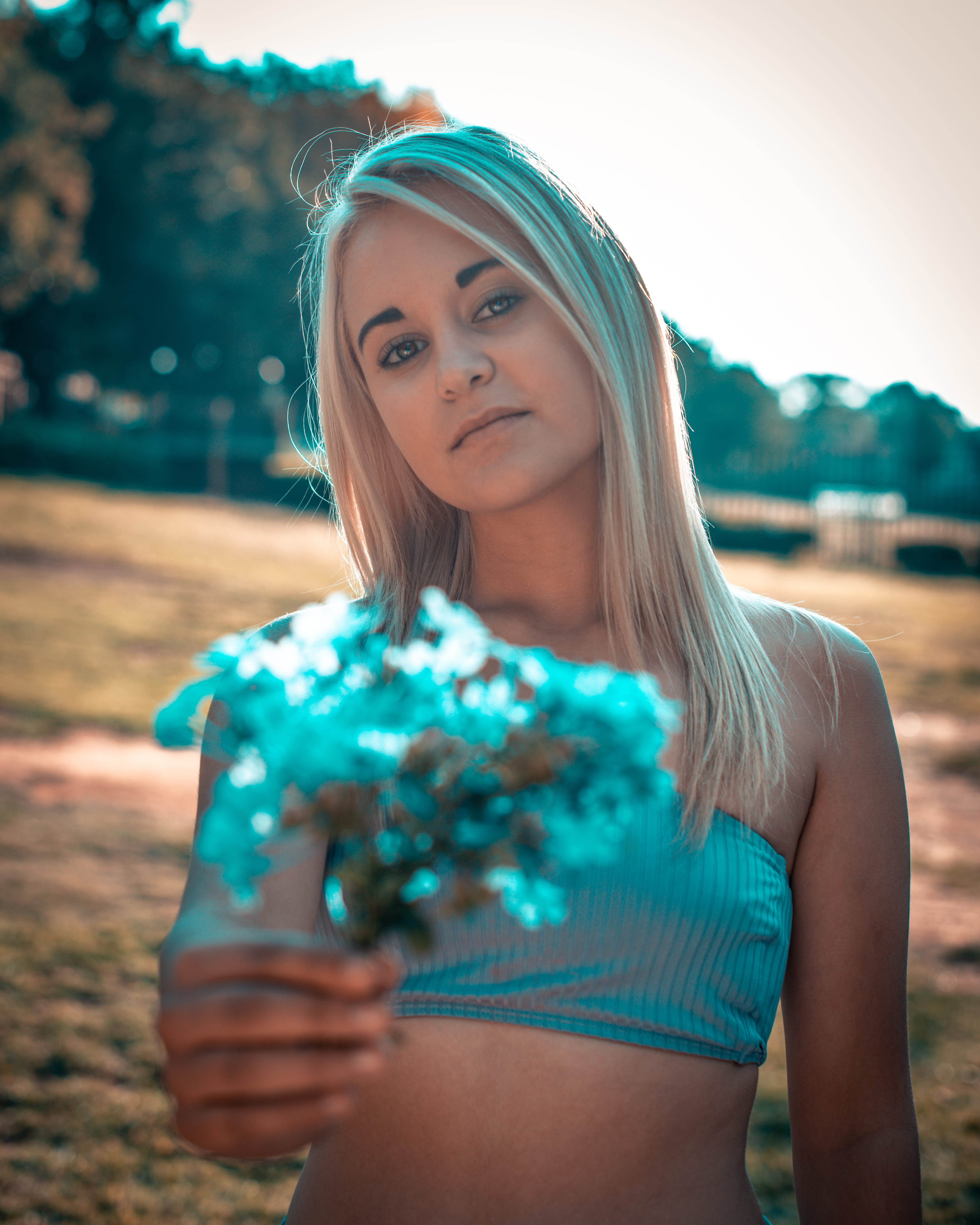 looking at camera, young adult, beautiful woman, lifestyles, standing, blond hair, hairstyle, young women, long hair, 5K, real people, blue flowers, tube top, Phone HD Wallpaper