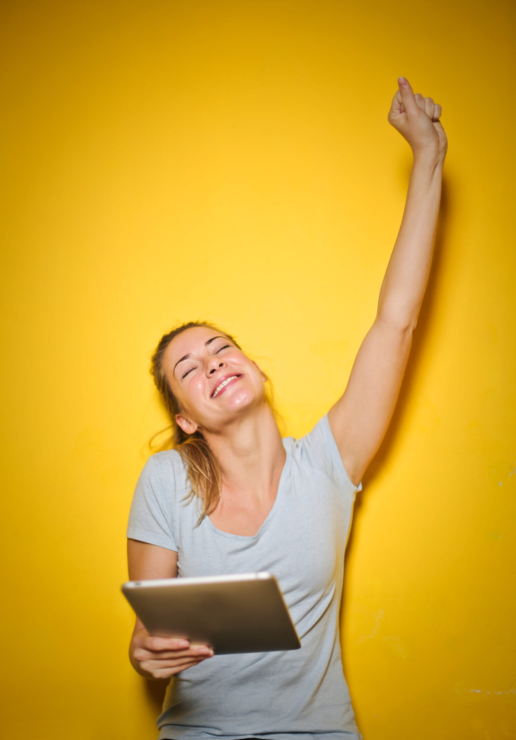 yellow background, computer, woman, ipad, exult, yellow, caucasian, young adult, online, touch pad, arms raised, triumph, Old, blue t-shirt, front view, Phone HD Wallpaper