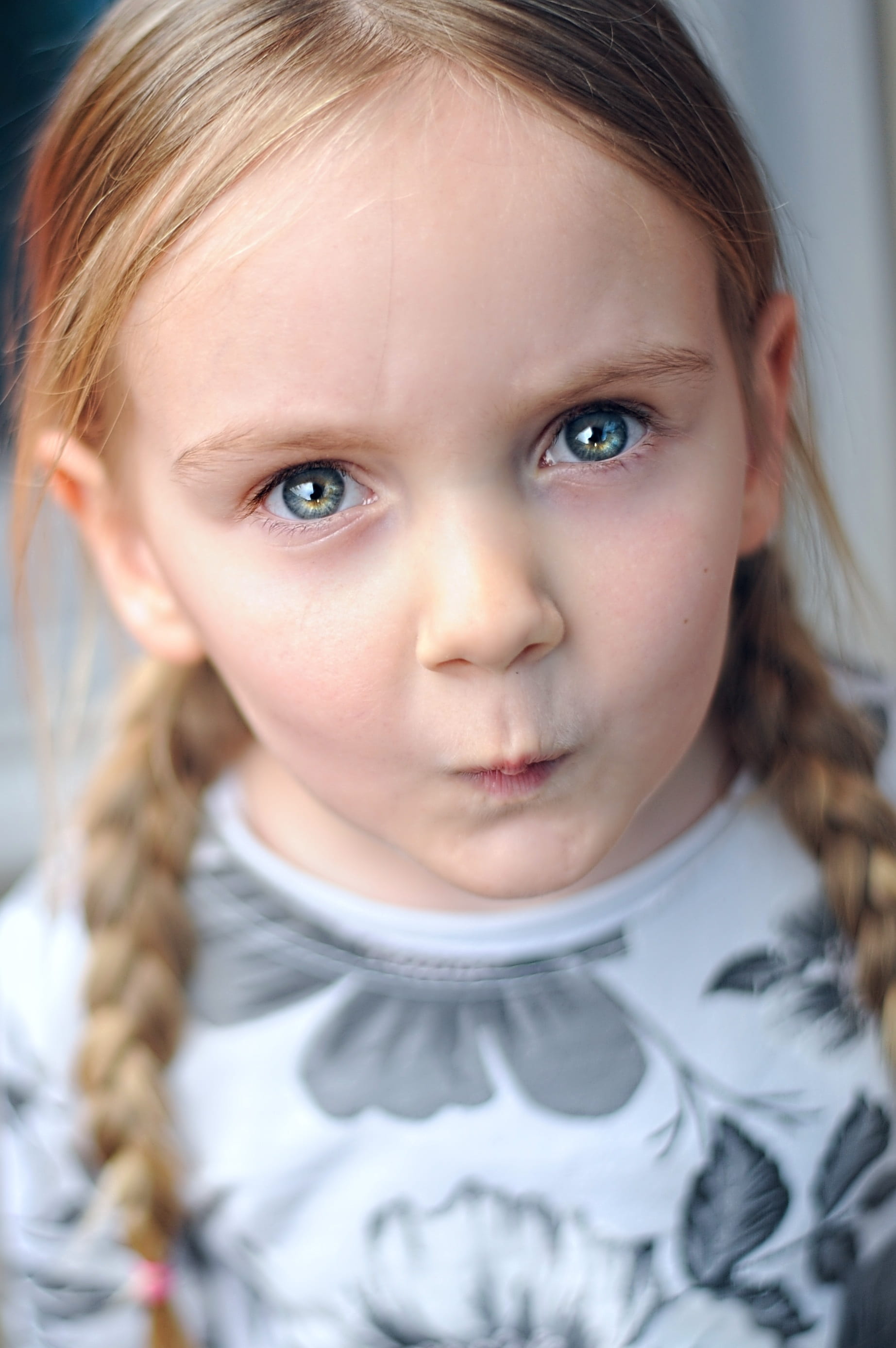 child, focus on foreground, cute, neck, fun, portrait, human face, hairstyle, childhood, girls, indoors, sleeved, face, front view, girl, grey, white, real people, Phone HD Wallpaper