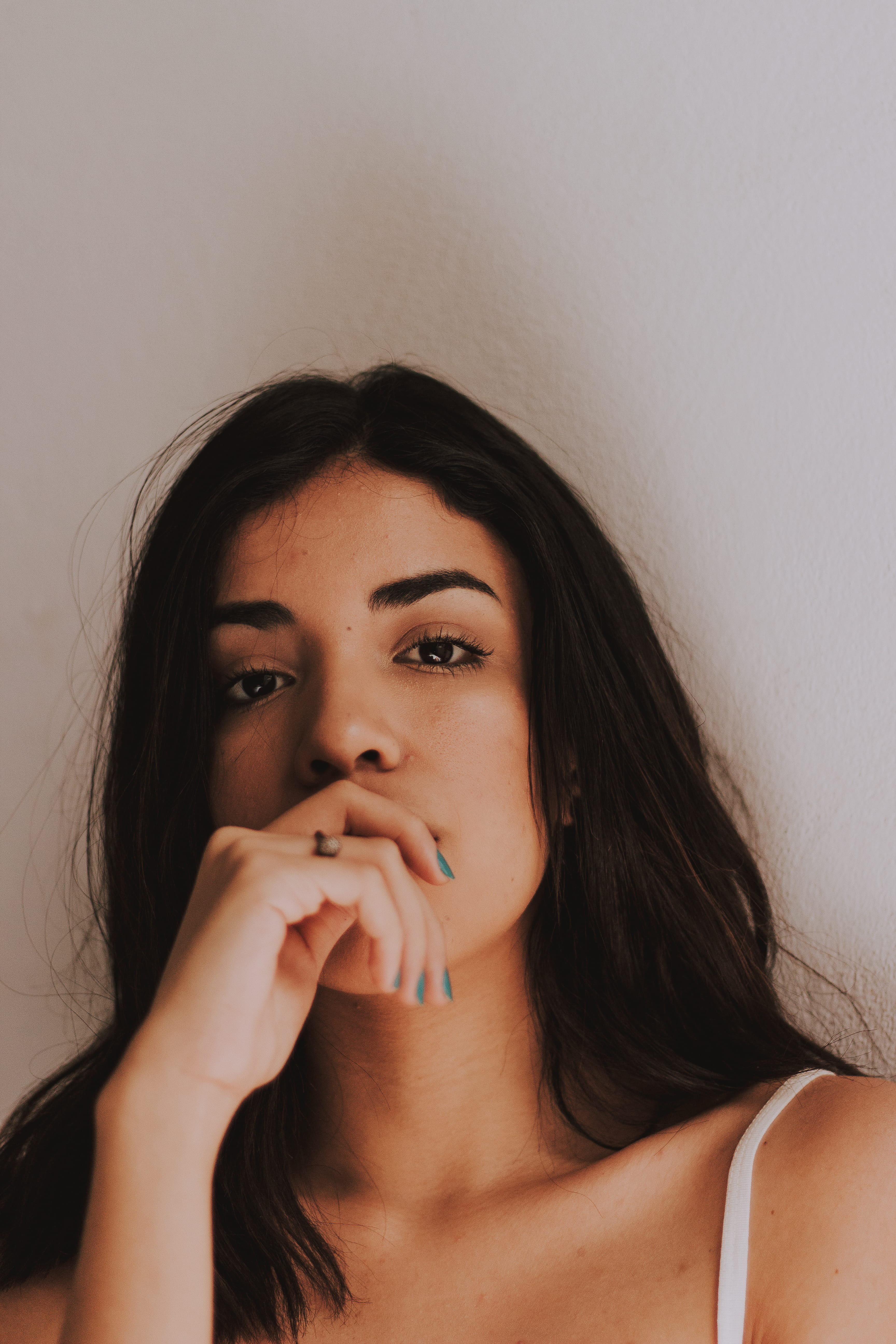 woman, contemplation, mouth, long hair, leisure activity, hand, 5K, beautiful, person, looking at camera, wall - building feature, young women, covering, Phone HD Wallpaper