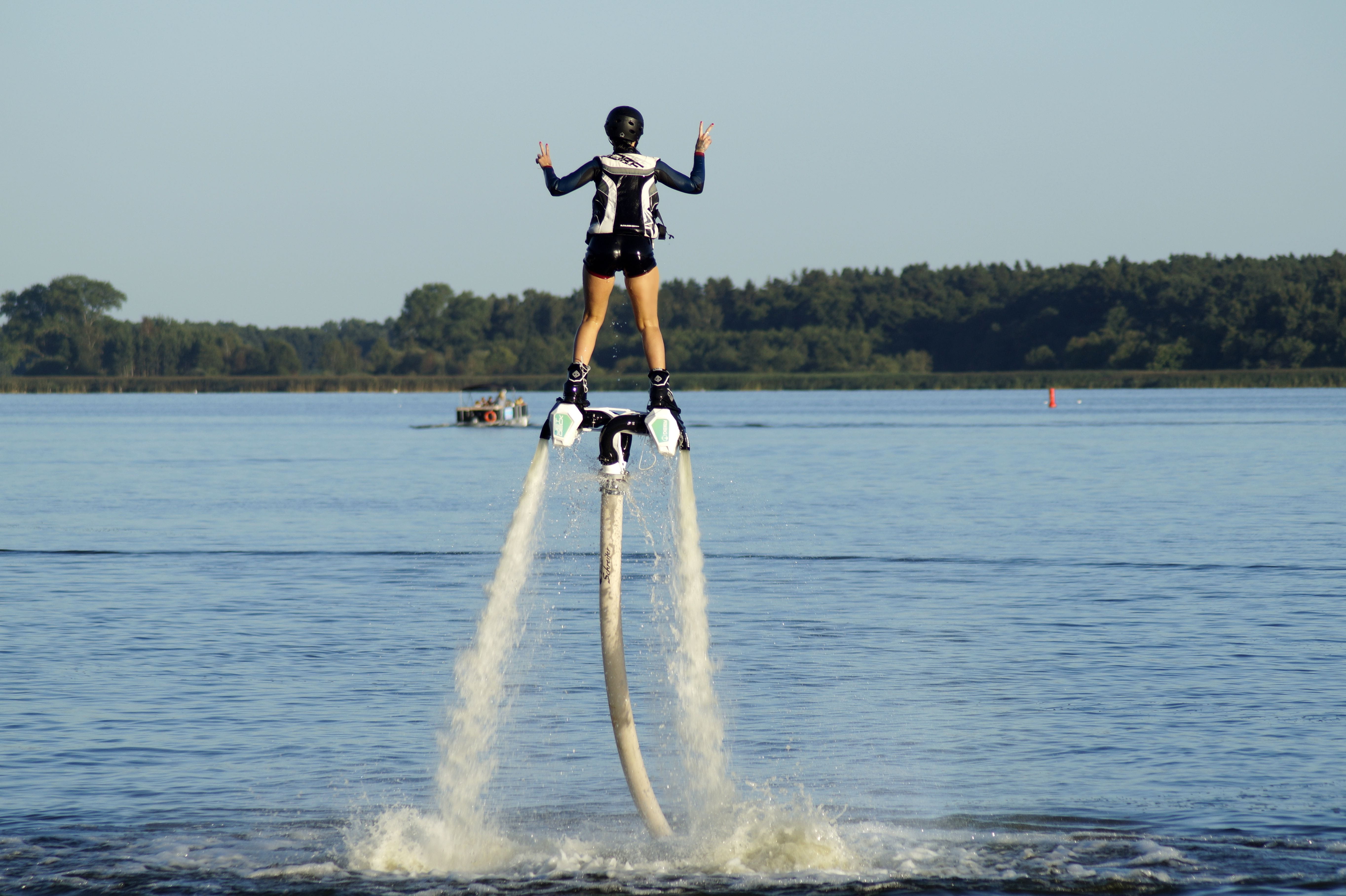 sport, men, skill, lifestyles, real people, flyboard, arms raised, tree, 5K, water jet, day, waterfront, woman, jetpack, beauty in nature, one person, HD Wallpaper