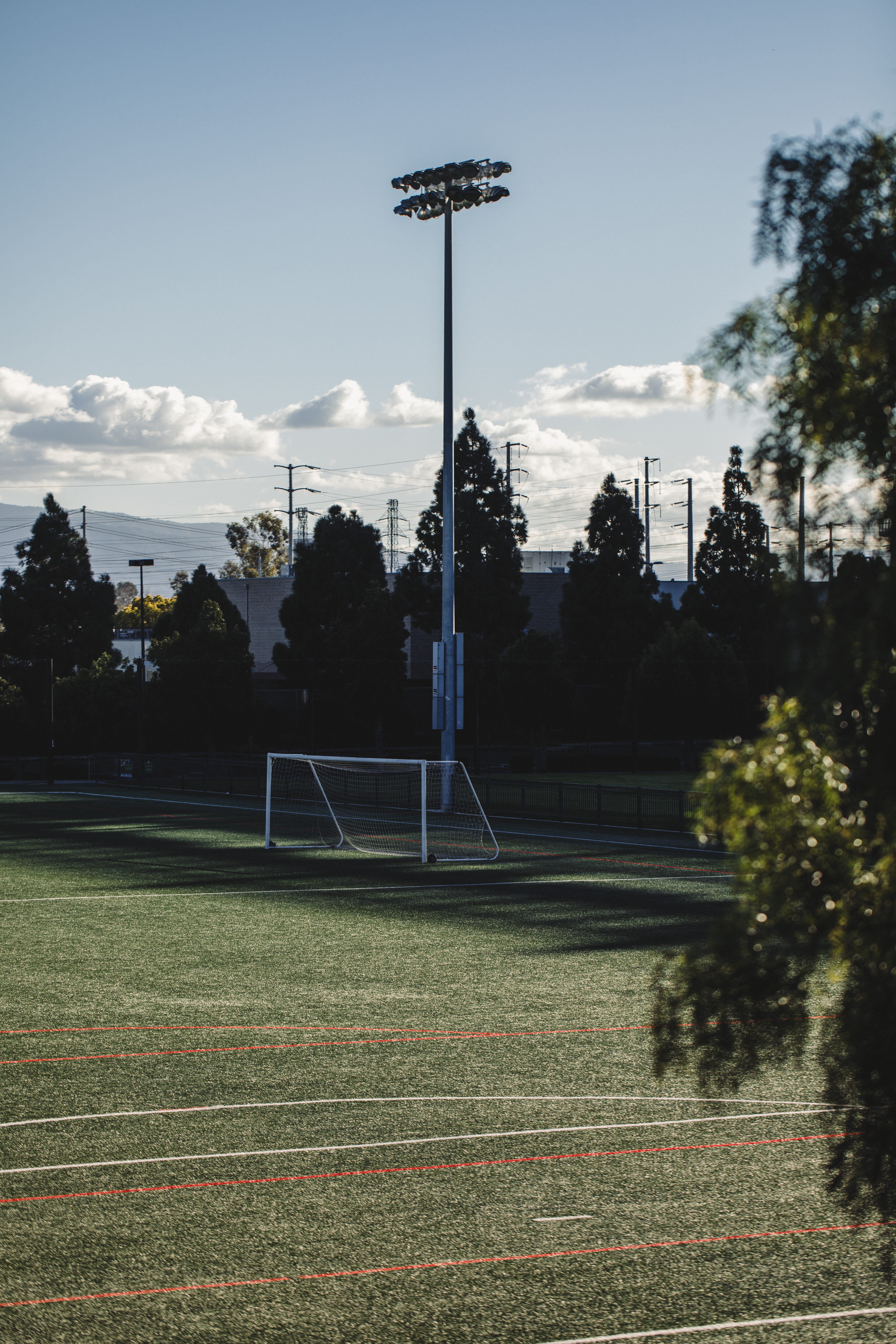 team, arena, lighting equipment, playing field, cloud - sky, land, apparel, team sport, post, absence, empty, sky, soccer, no people, soccer field, tree, Phone HD Wallpaper