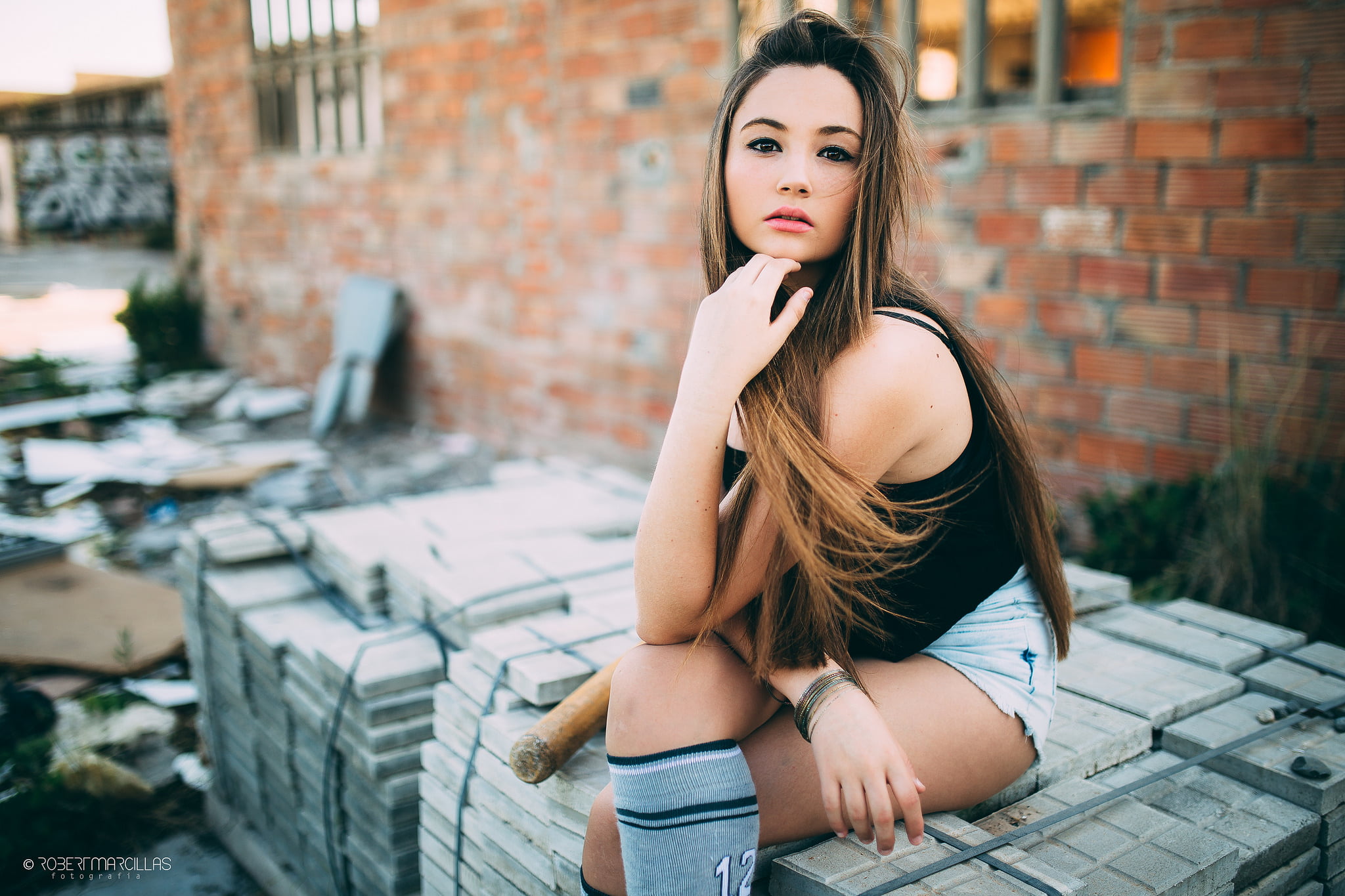 outdoors, brunette, looking at camera, model, sitting, beautiful woman, fashion, 1080P, hair, young adult, legs crossed, wall, portrait, front view, contemplation, HD Wallpaper