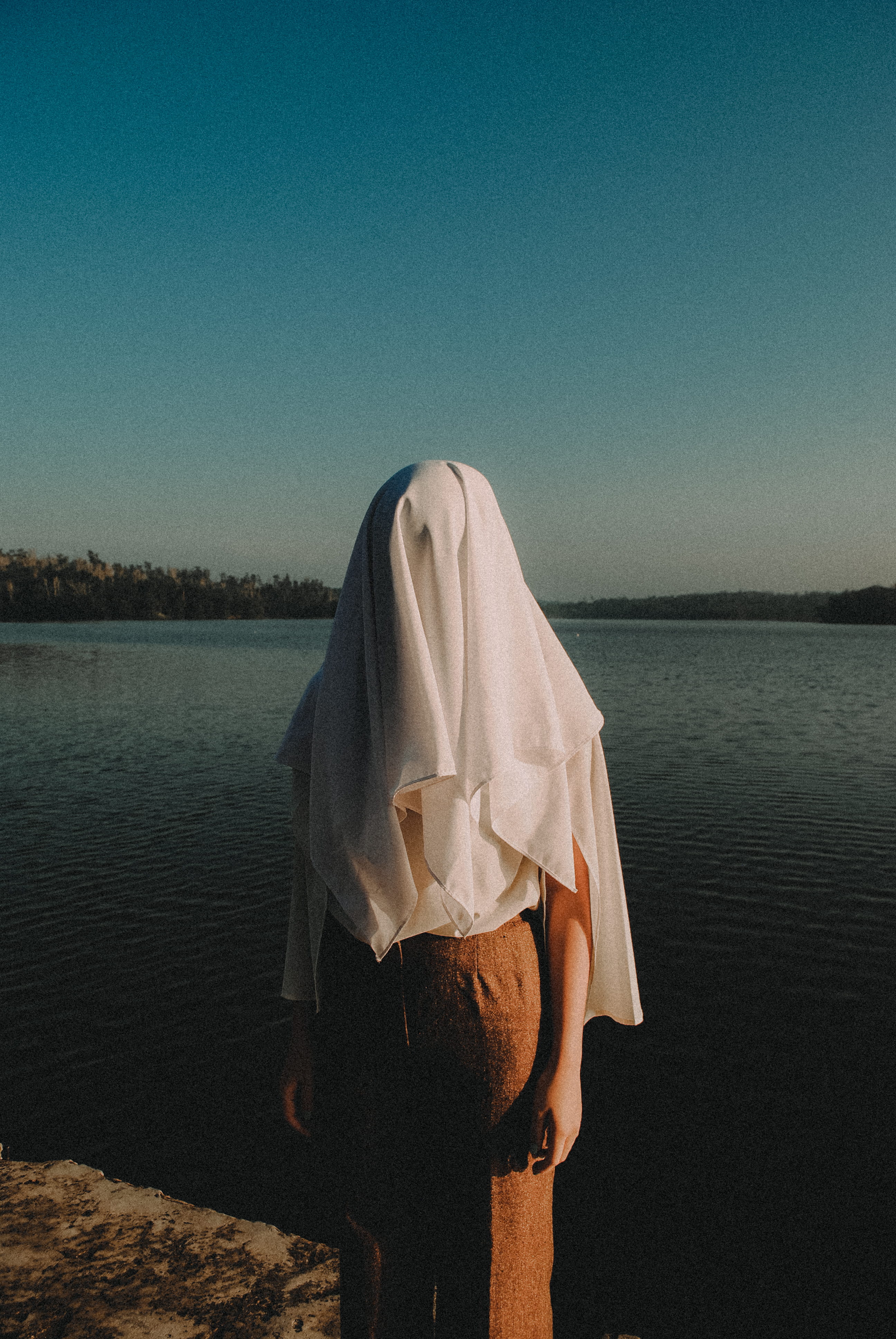 sunlight, outdoors, near, sea, real people, clothing, one person, hide, covered, tree, body, white, wearing, ghost, lake, casual clothing, concept, sky, Phone HD Wallpaper
