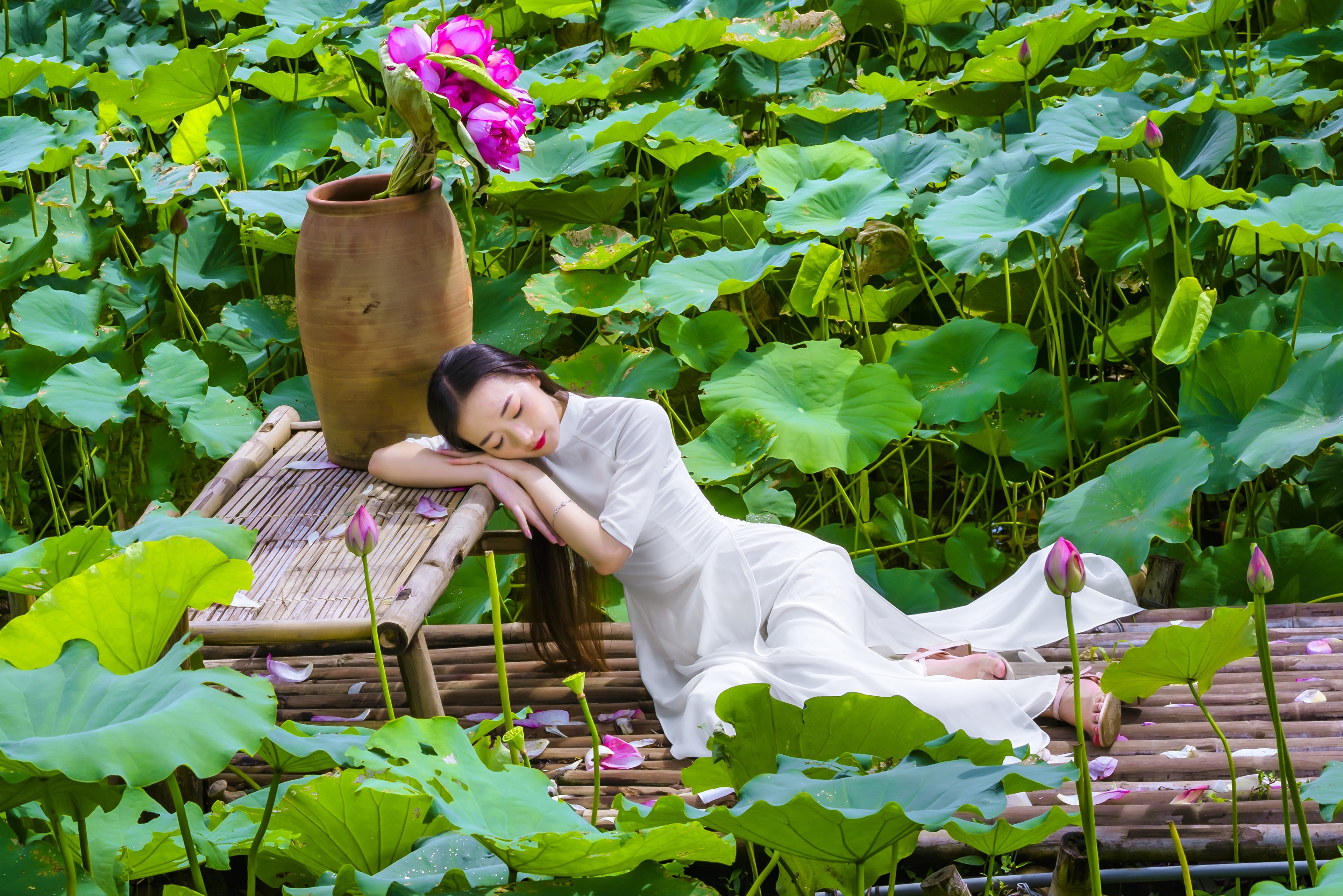 flowers, bracelets, wooden walkway, laying on side, model, women, 4K, leaves, flowerpot, brunette, pink heels, long hair, traditional clothing, red lipstick, HD Wallpaper