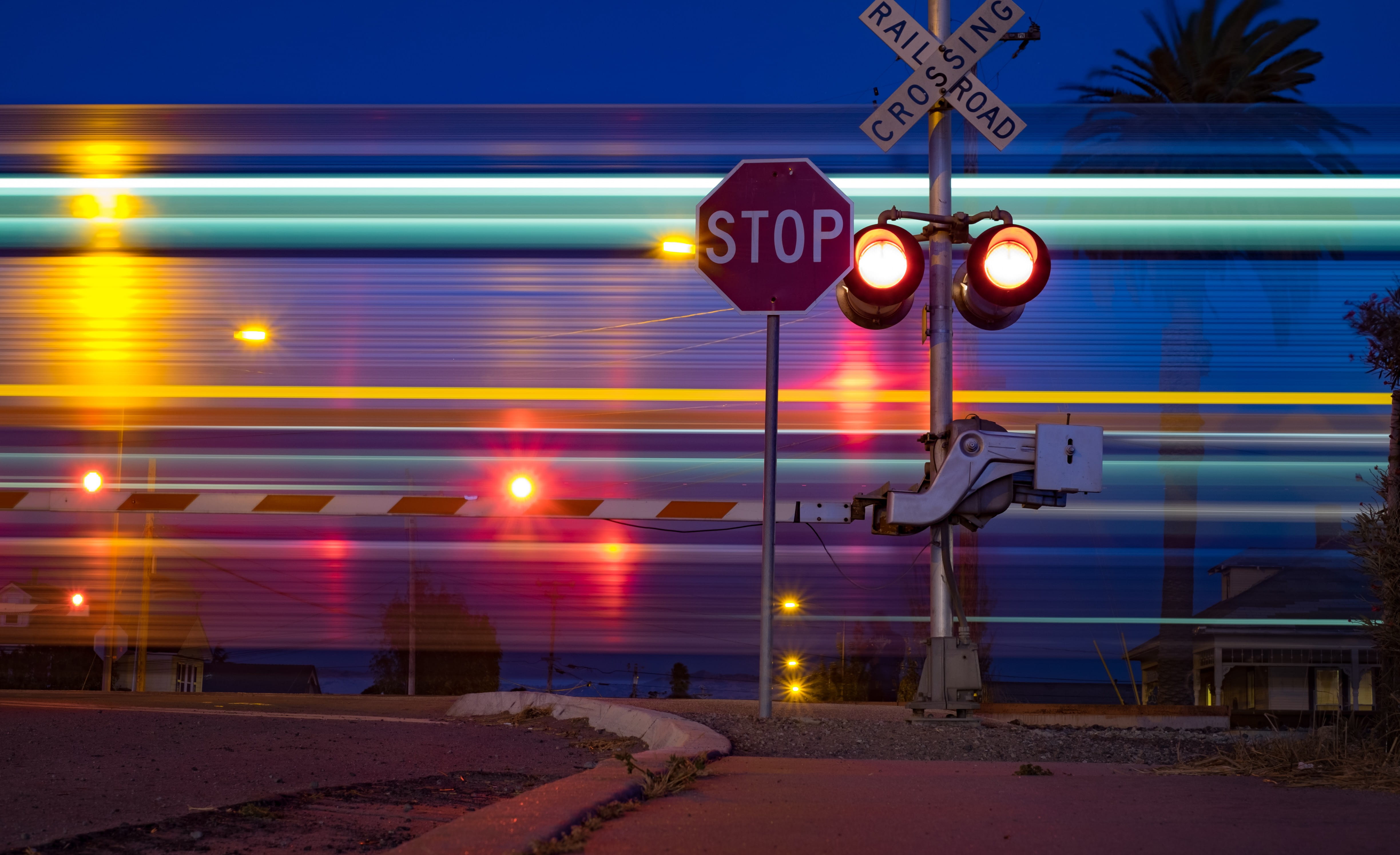 track, beside, railroad, time, no people, signs, palm tree, crossing sign, train, crossing, outdoors, motion, nighttime, barrier, 4K, light, communication, HD Wallpaper