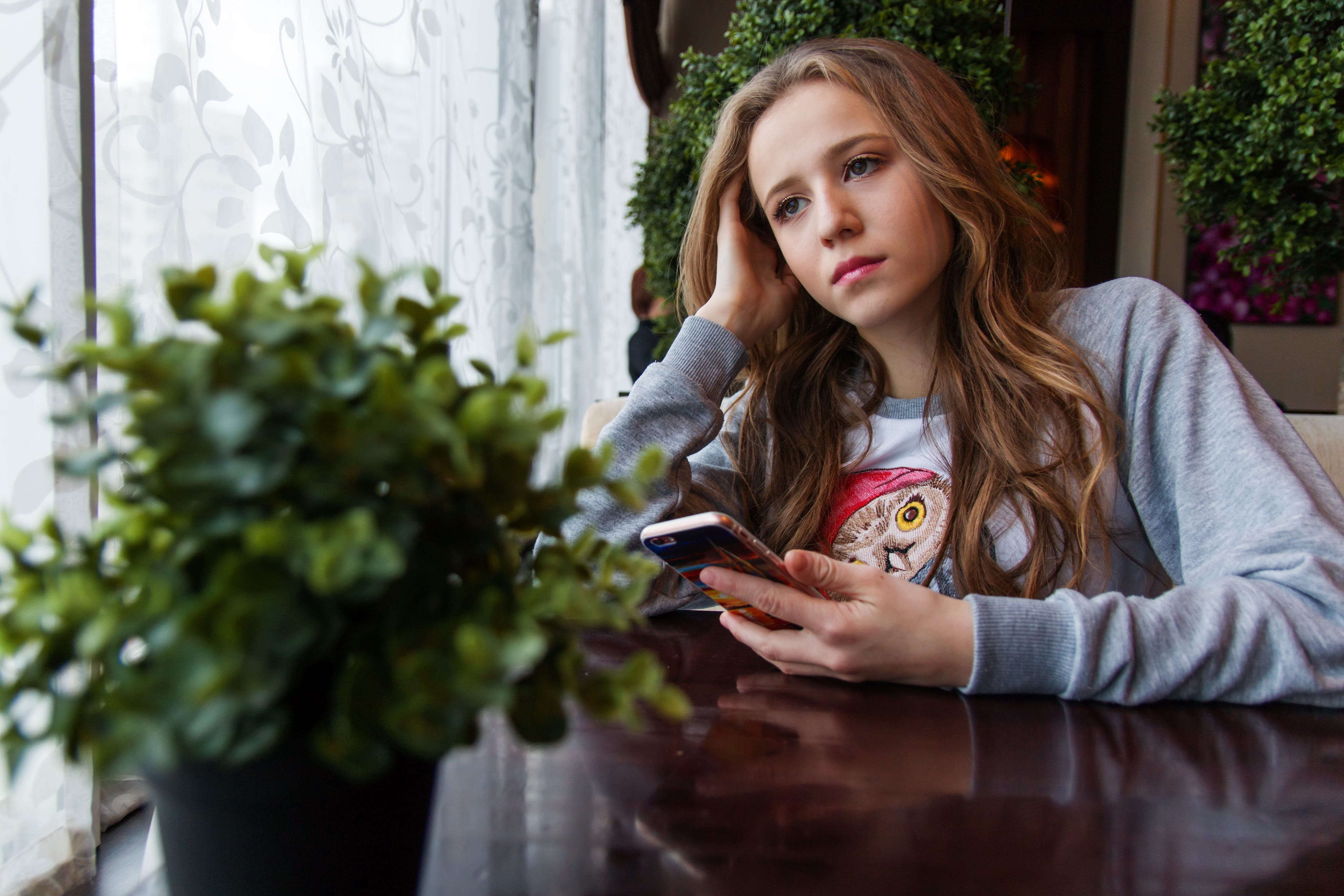 view, smart phone, boredom, holding, hairstyle, beauty, woman, window, women, curtain, waiting for a call, lifestyles, flowers, youth, connection, gray, HD Wallpaper