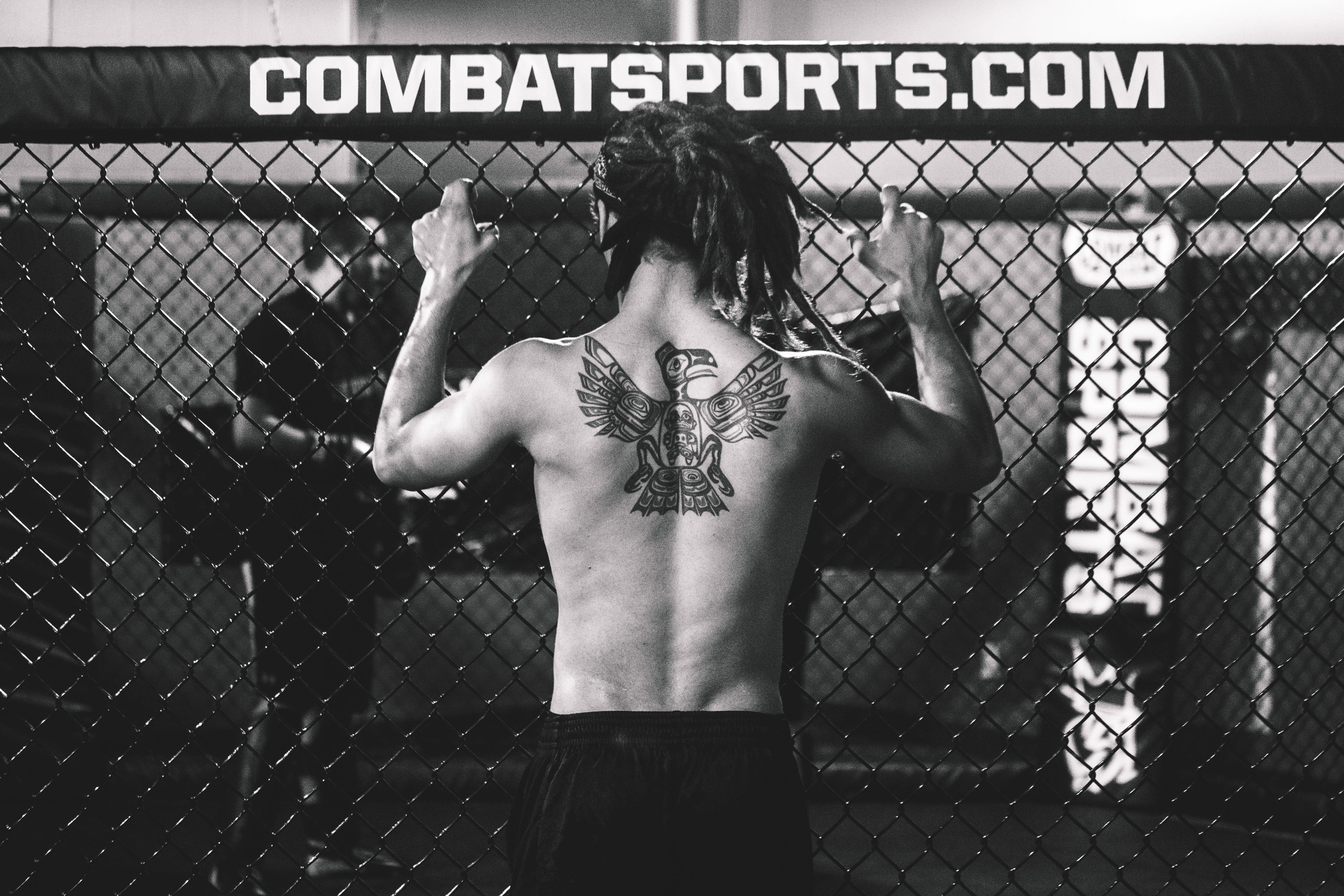 leisure activity, fence, men, martial Arts, text, chainlink fence, shirtless, fighter, western script, rear view, boundary, tattoos, real people, mMA, standing, HD Wallpaper