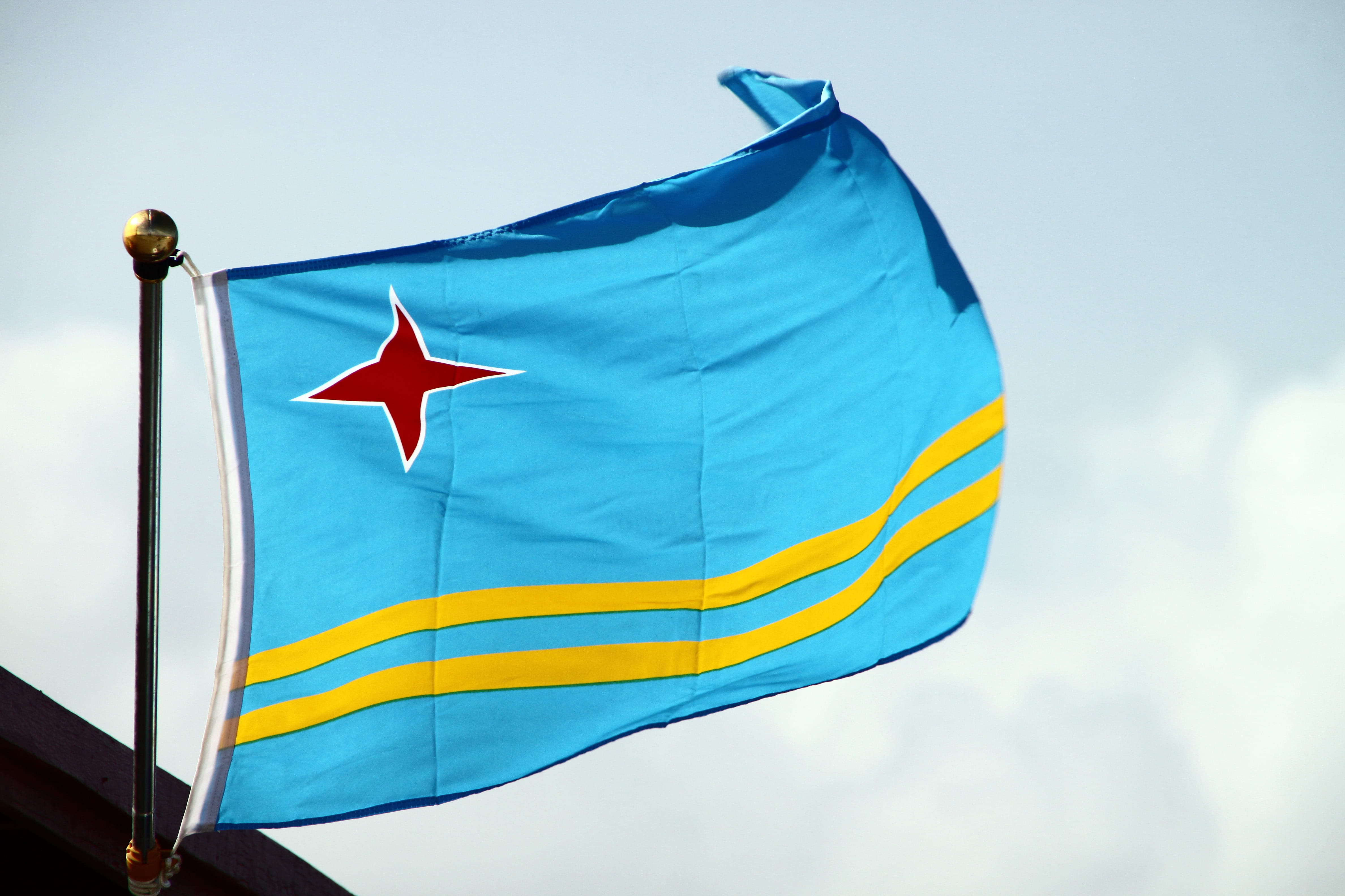 cloud - sky, Yellow, motion, day, Flag, environment, sky, waving, red, close-up, shape, blue, aruba, 4K, textile, low angle view, no people, patriotism, HD Wallpaper
