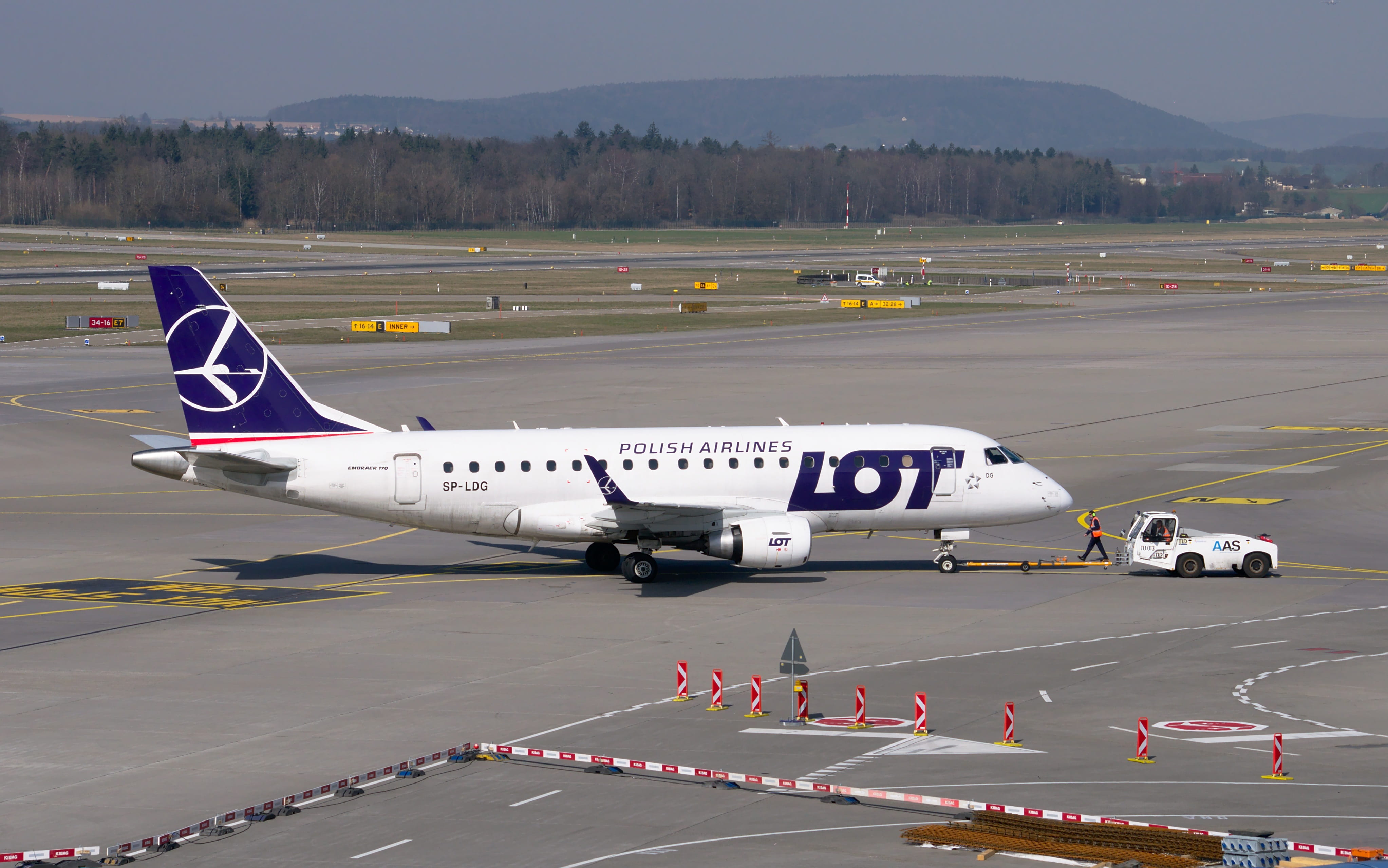 sign, embraer, private airplane, land, tug, zurich, day, towing vehicle, no people, mountain, outdoors, 4K, transportation, side view, tarmac, tractor, HD Wallpaper