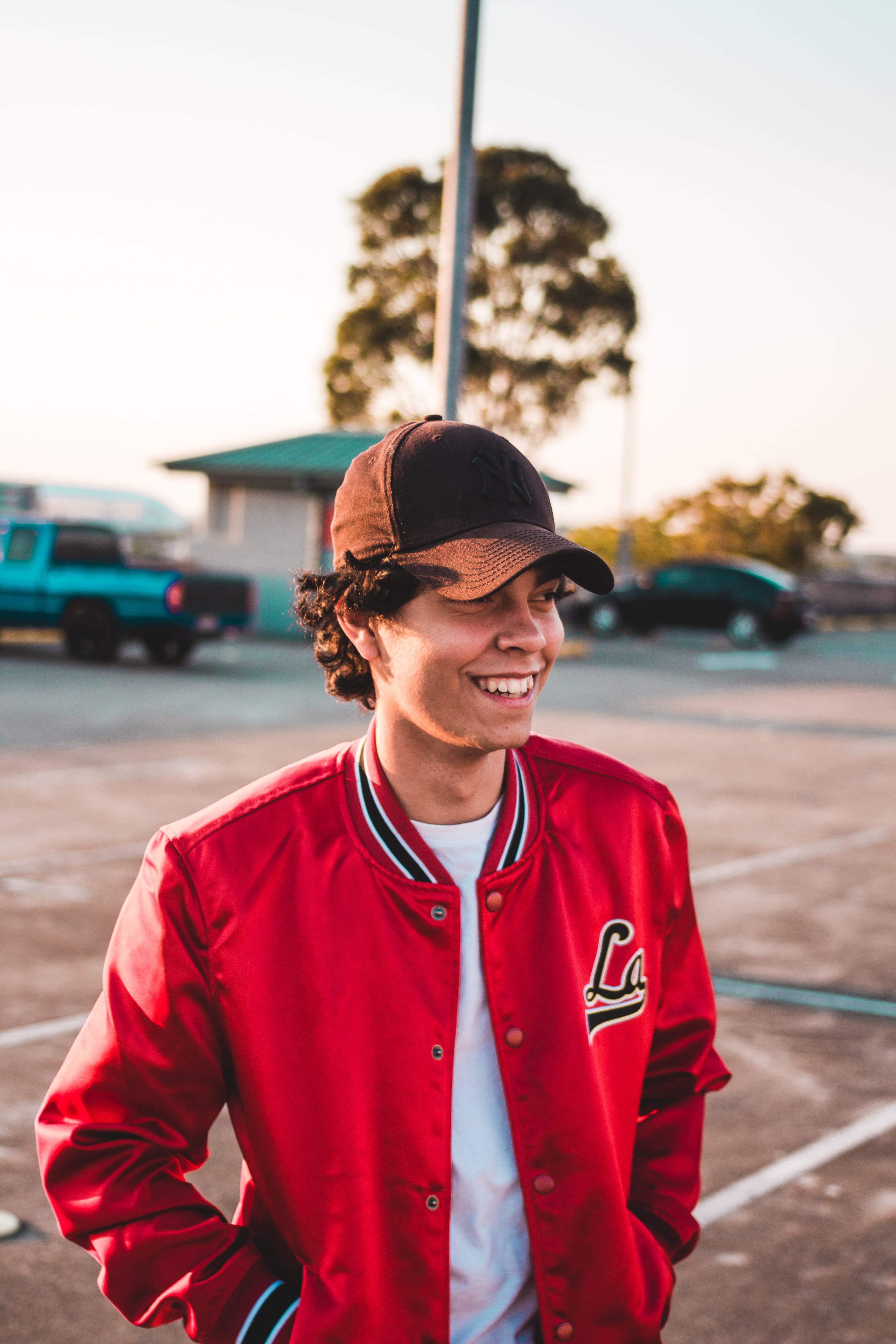 sunglasses, near, golden hour, one person, waist up, red, parking lot, fashion, car, clothing, person, smiling, front view, real people, lifestyles, human, Phone HD Wallpaper