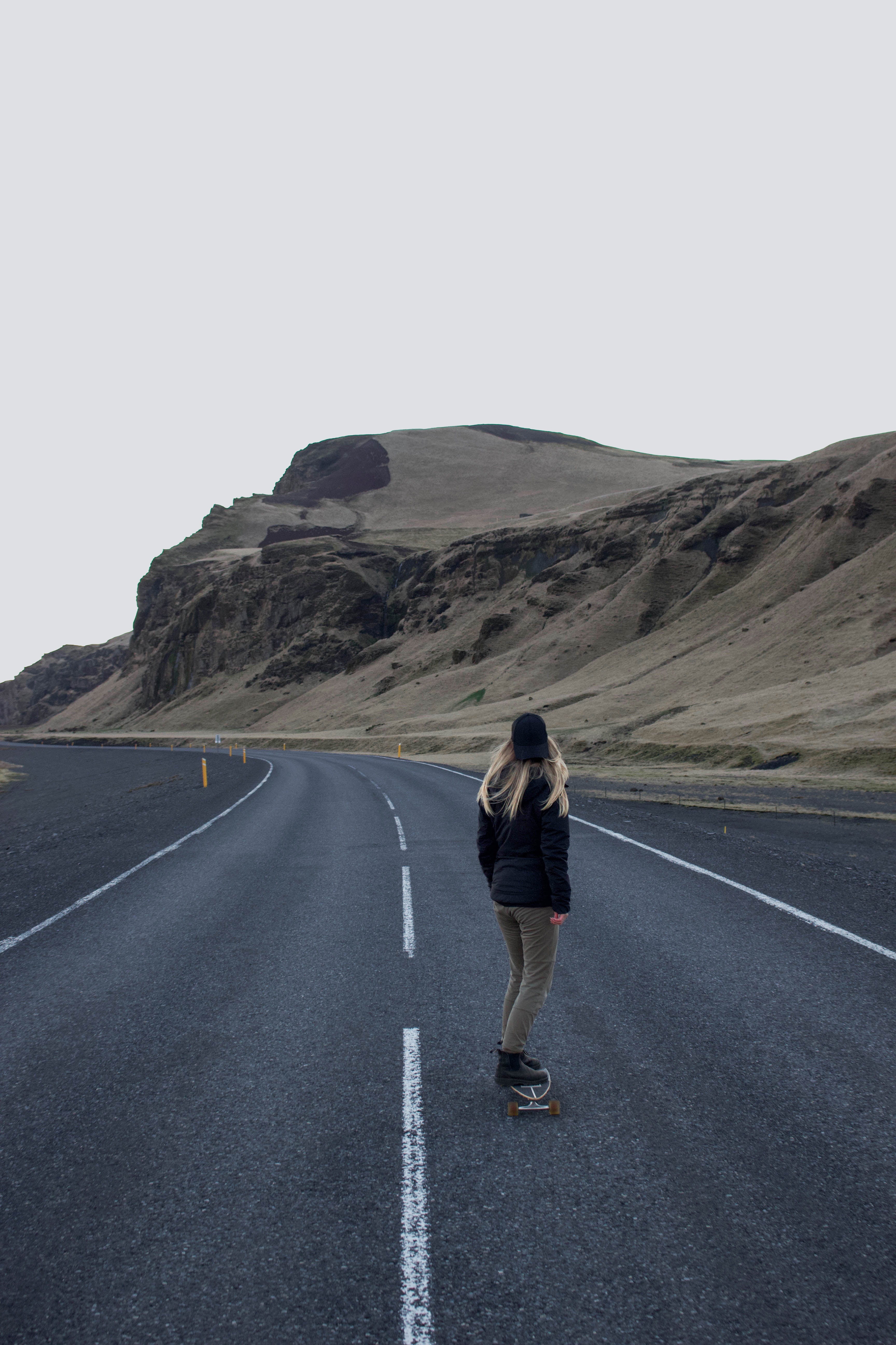 jacket, 5K, gray, mountain, sky, skater, person, sign, one person, full length, female, day, girl, clear sky, woman, lifestyles, lady, longboarding, road, Phone HD Wallpaper
