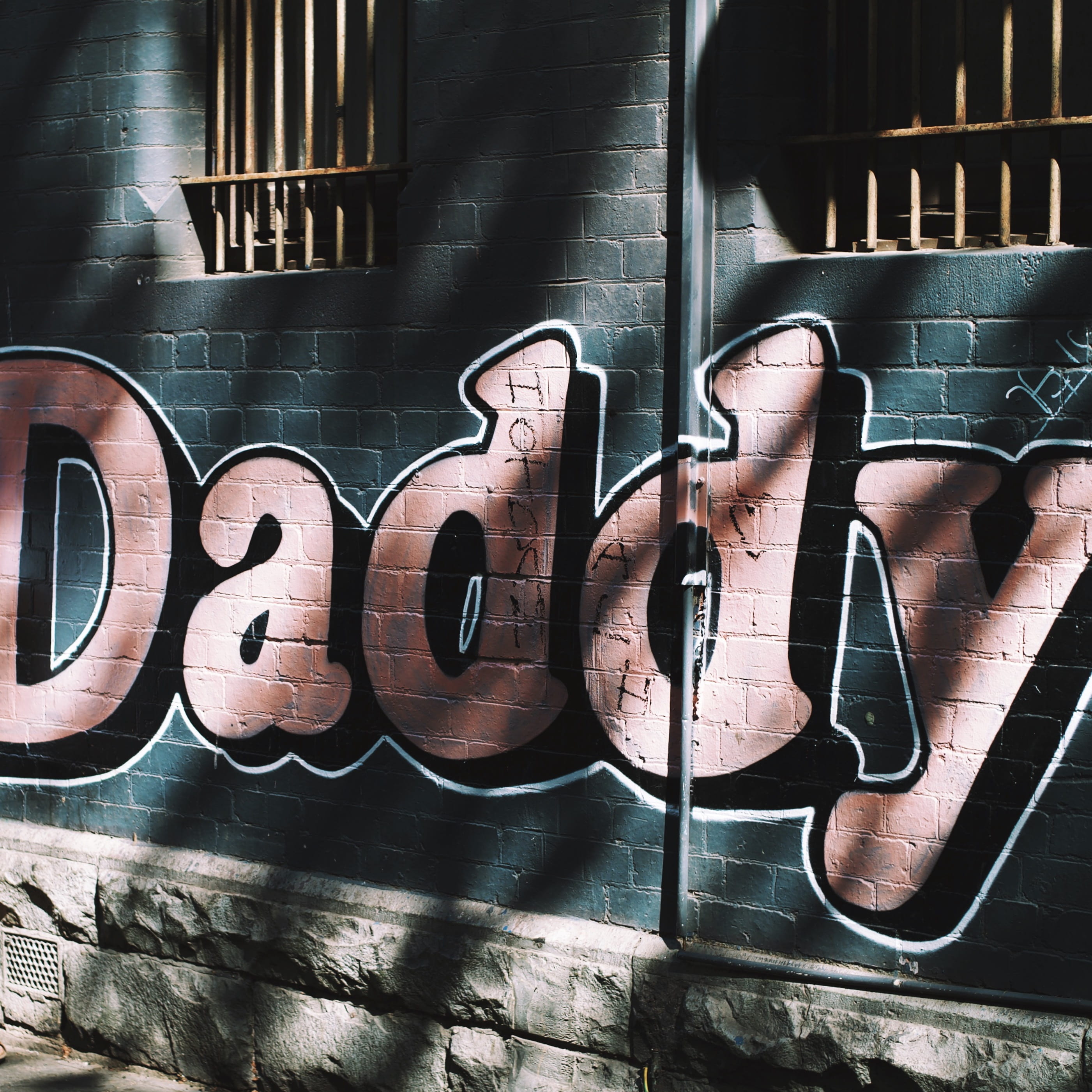 creativity, arte de rua, sunlight, music, architecture, graffiti, stone, built structure, text, art, no people, concrete, shadow, string instrument, close-up, Phone HD Wallpaper