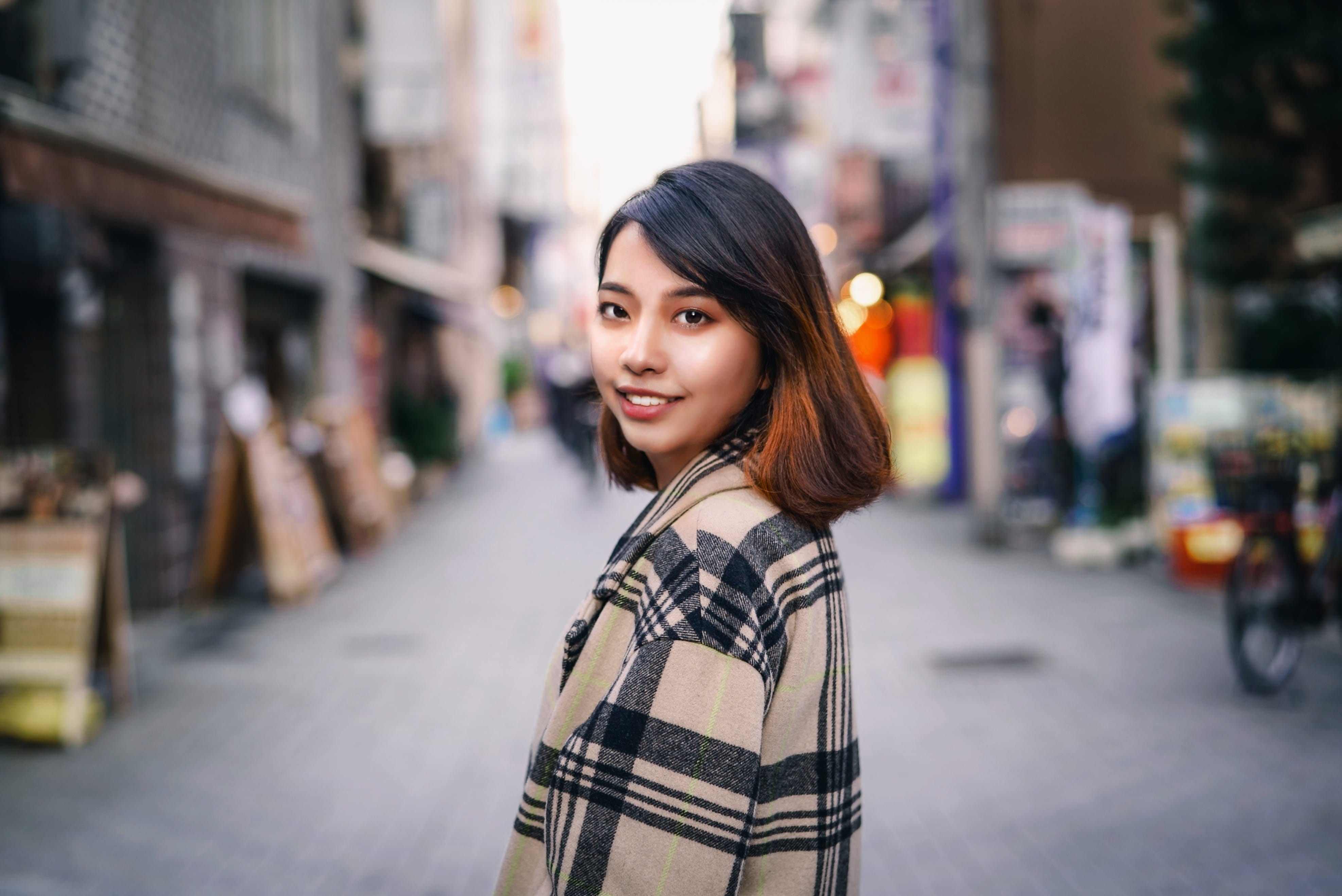 focus on foreground, looking at camera, girl, city life, hairstyle, one person, 4K, japanese, urban, hair, black hair, turning, woman, japan, brown eyes, HD Wallpaper