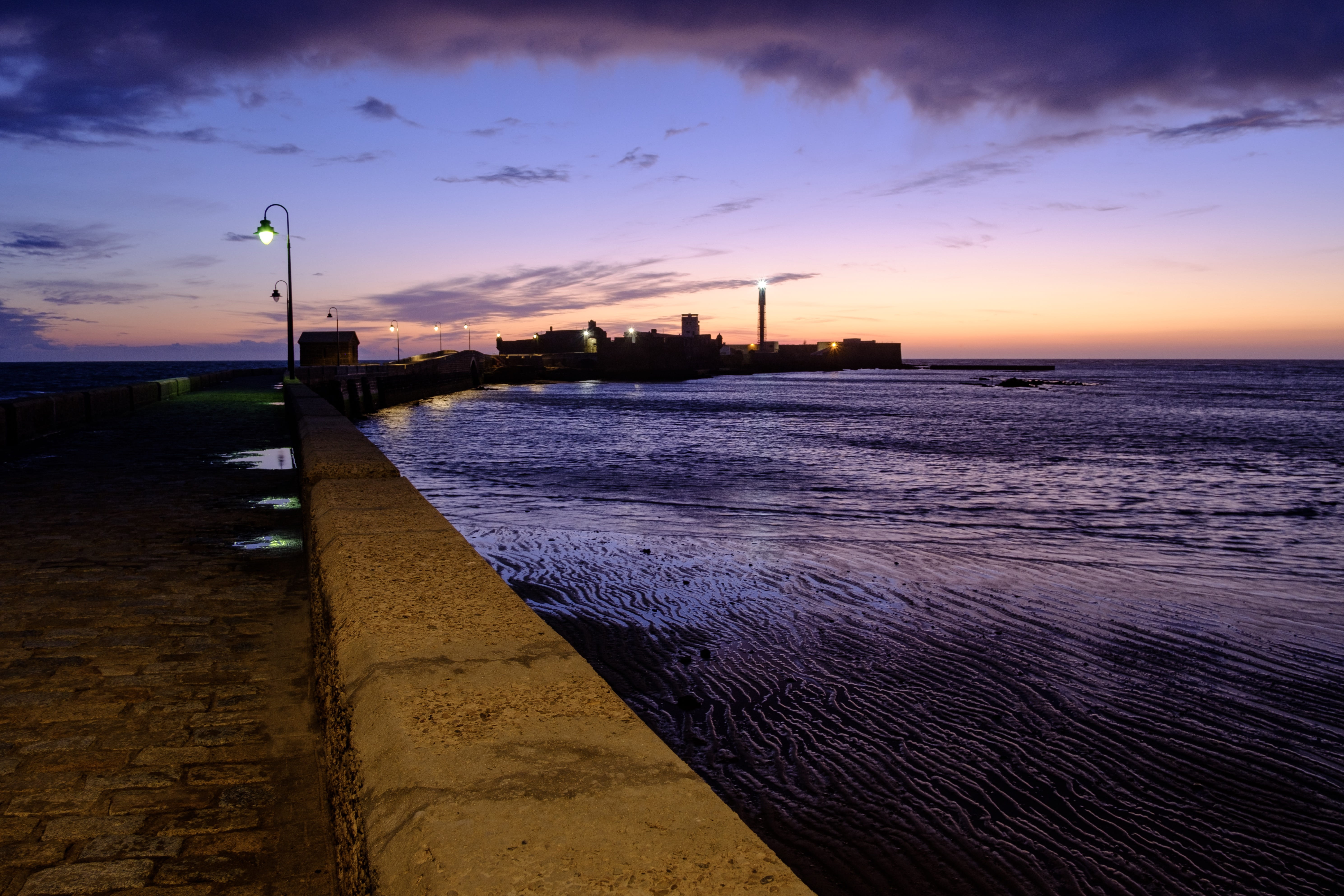 path, port, orange color, sunset, lights, relic, nature, no people, beach, street, stone, river, 5K, cadiz, sky, water, building exterior, street light, HD Wallpaper