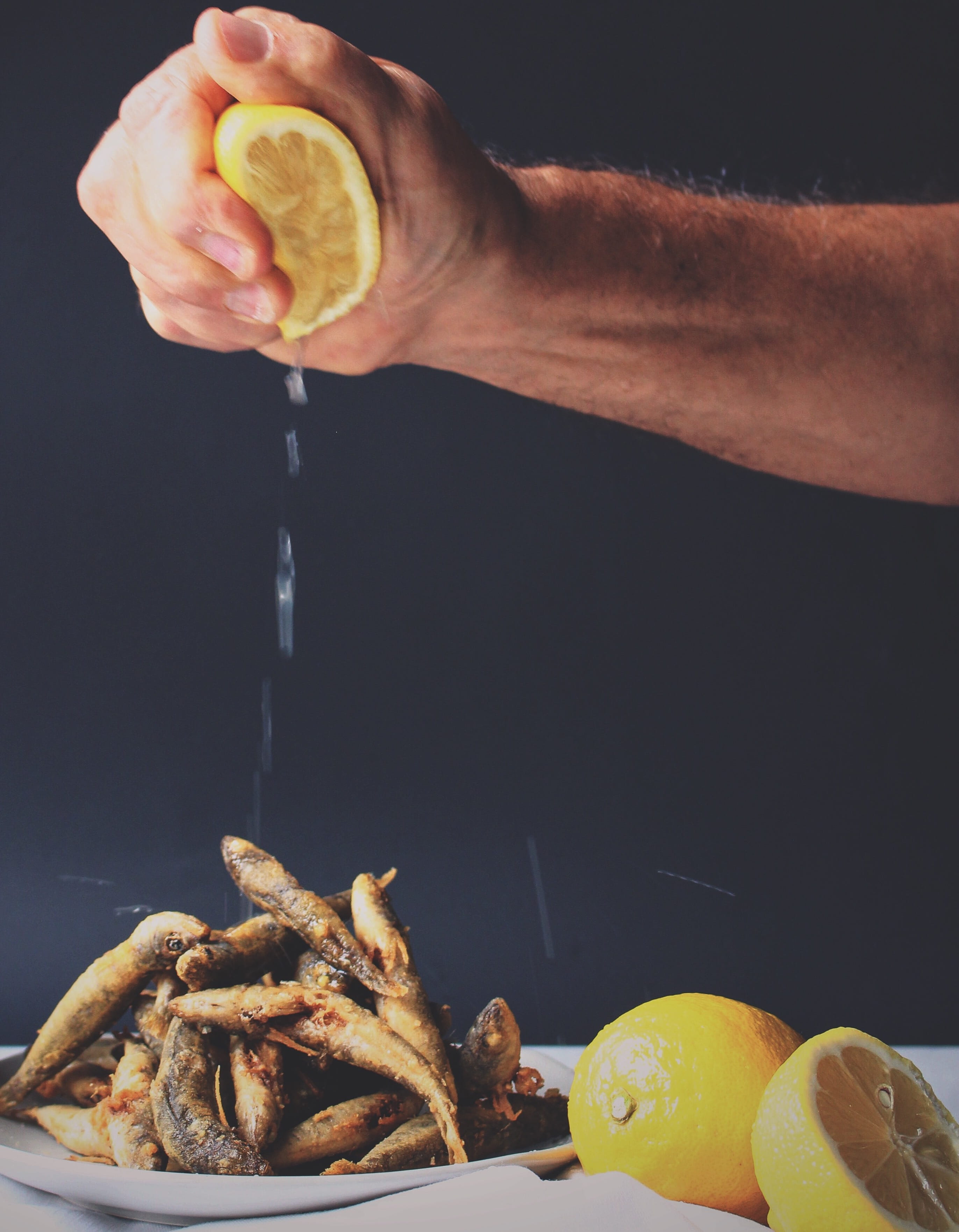 food, black background, one person, men, snack, fishes, real people, 2K, squeezing, citrus fruit, wellbeing, lemon, gourmet, preparing food, preparation, Phone HD Wallpaper