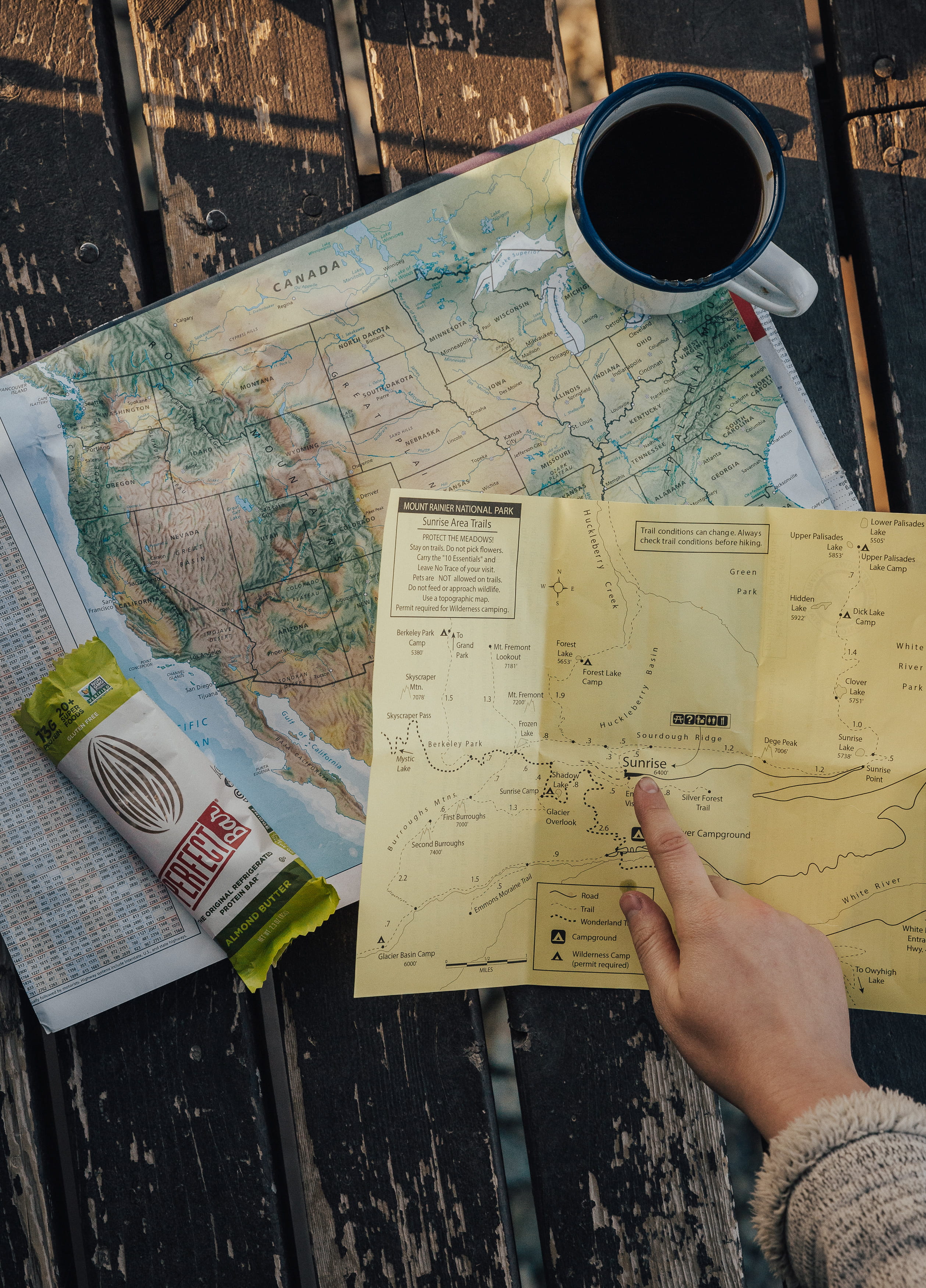table, protein snacks, holding, text, camping, atlas, navigate, real people, leisure activity, person, indoors, coffee cup, high angle view, compass, mug, Phone HD Wallpaper
