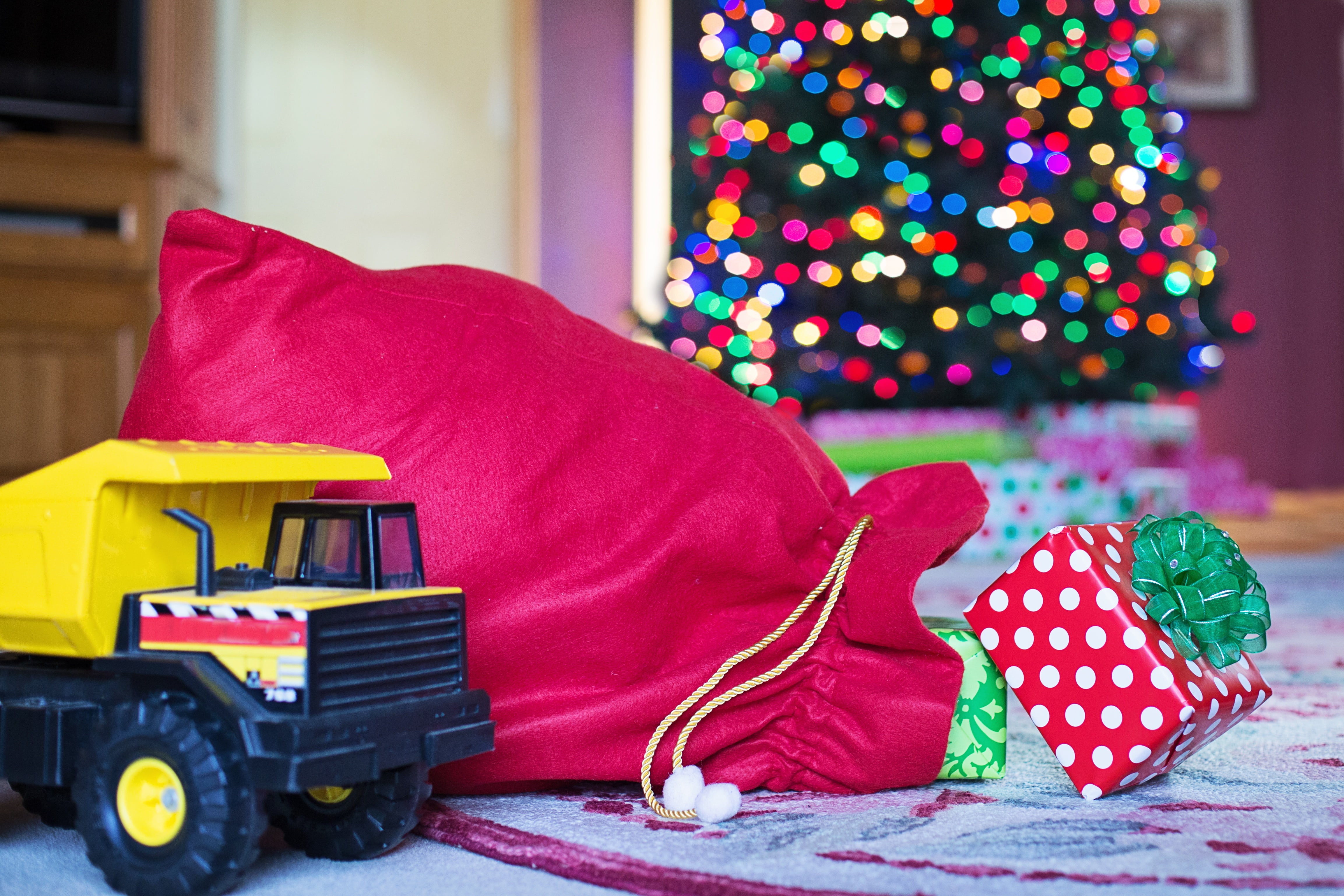 celebration, emotion, red, xmas gifts, polka dot, one person, 4K, focus on foreground, home interior, tree, gift, decoration, multi colored, toy, domestic room, HD Wallpaper