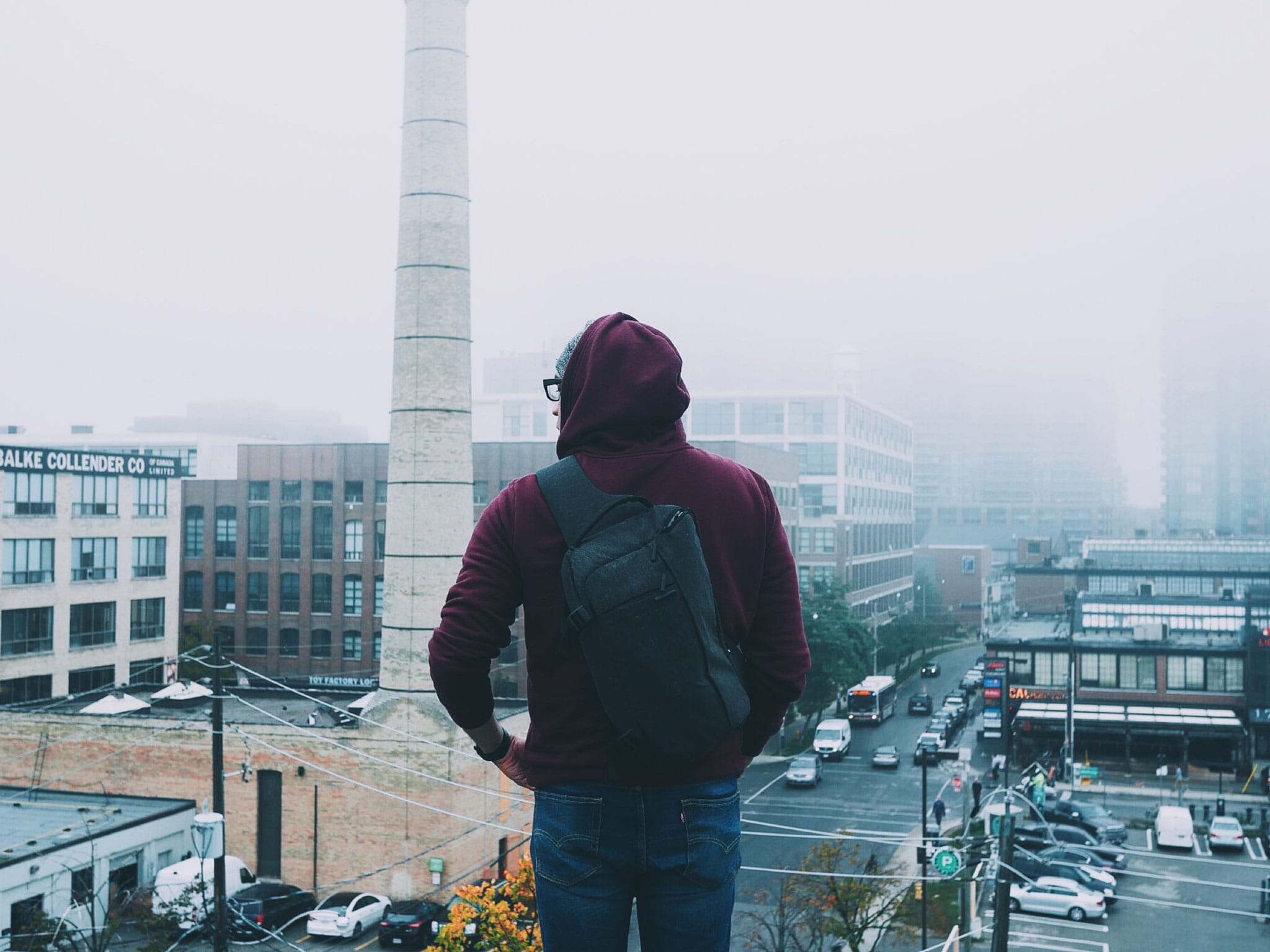 black, warm clothing, backpack, covered, wearing, skyscraper, top, daytime, city life, day, one person, three quarter length, winter, guy, architecture, HD Wallpaper