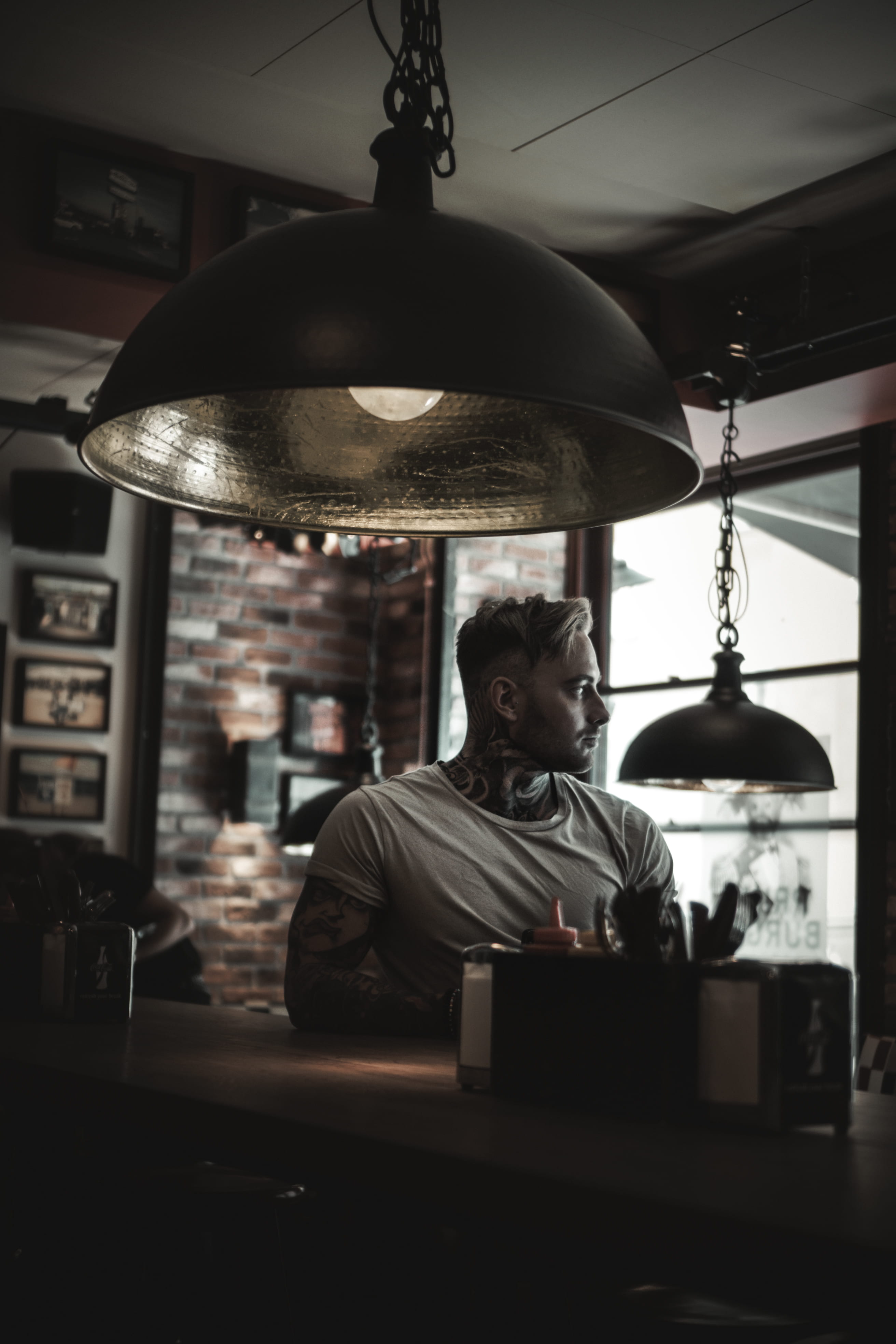 drink, one person, design, male, man, style, muscle, brick, tattoo, hanging, near, bar - drink establishment, 4K, lighting equipment, stool, real people, Phone HD Wallpaper