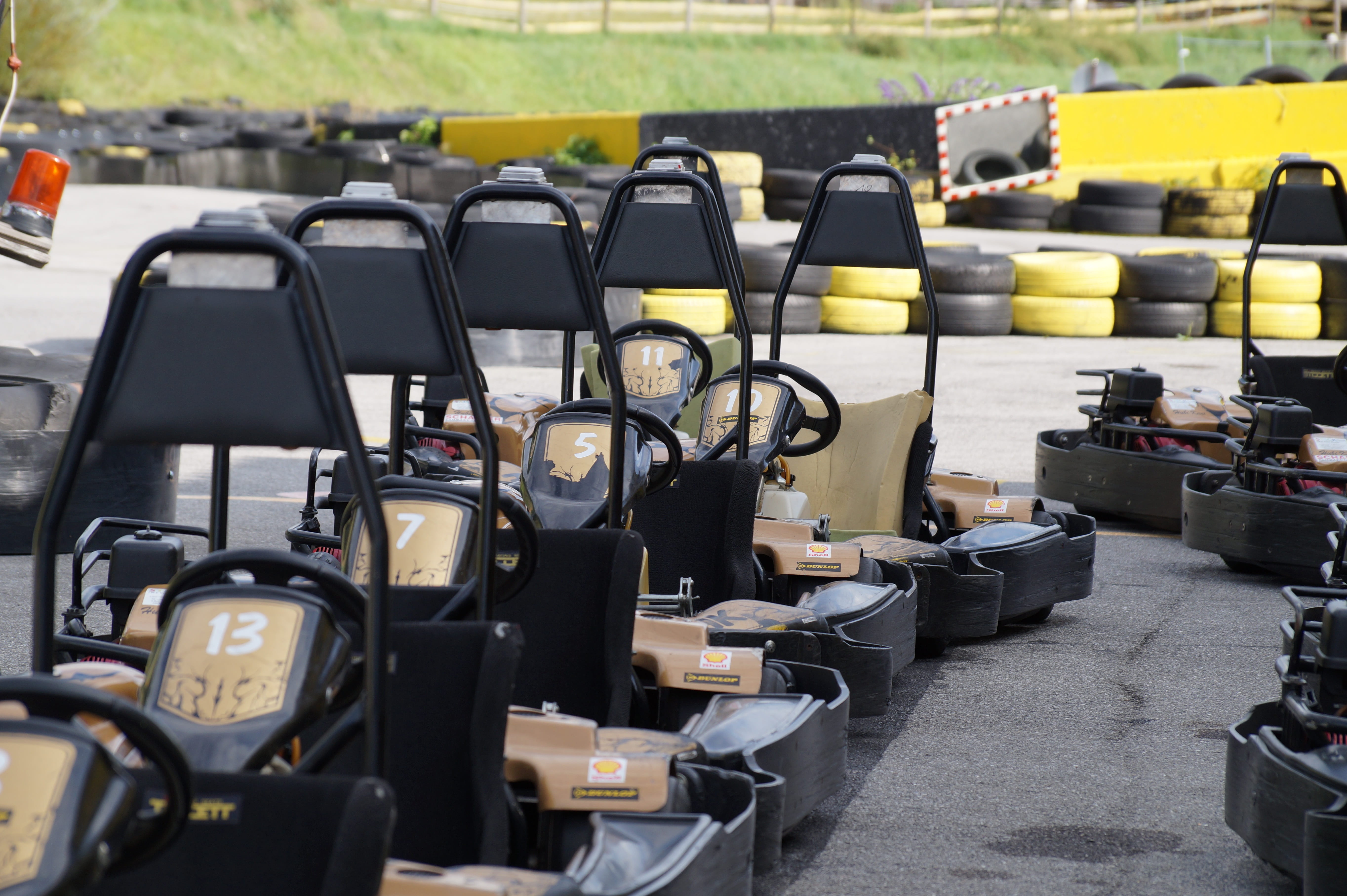 no people, large group of objects, speed, racecourse, yellow, race, 5K, go kart, table, go kart track, car, empty, focus on foreground, outdoors, kart racing, HD Wallpaper