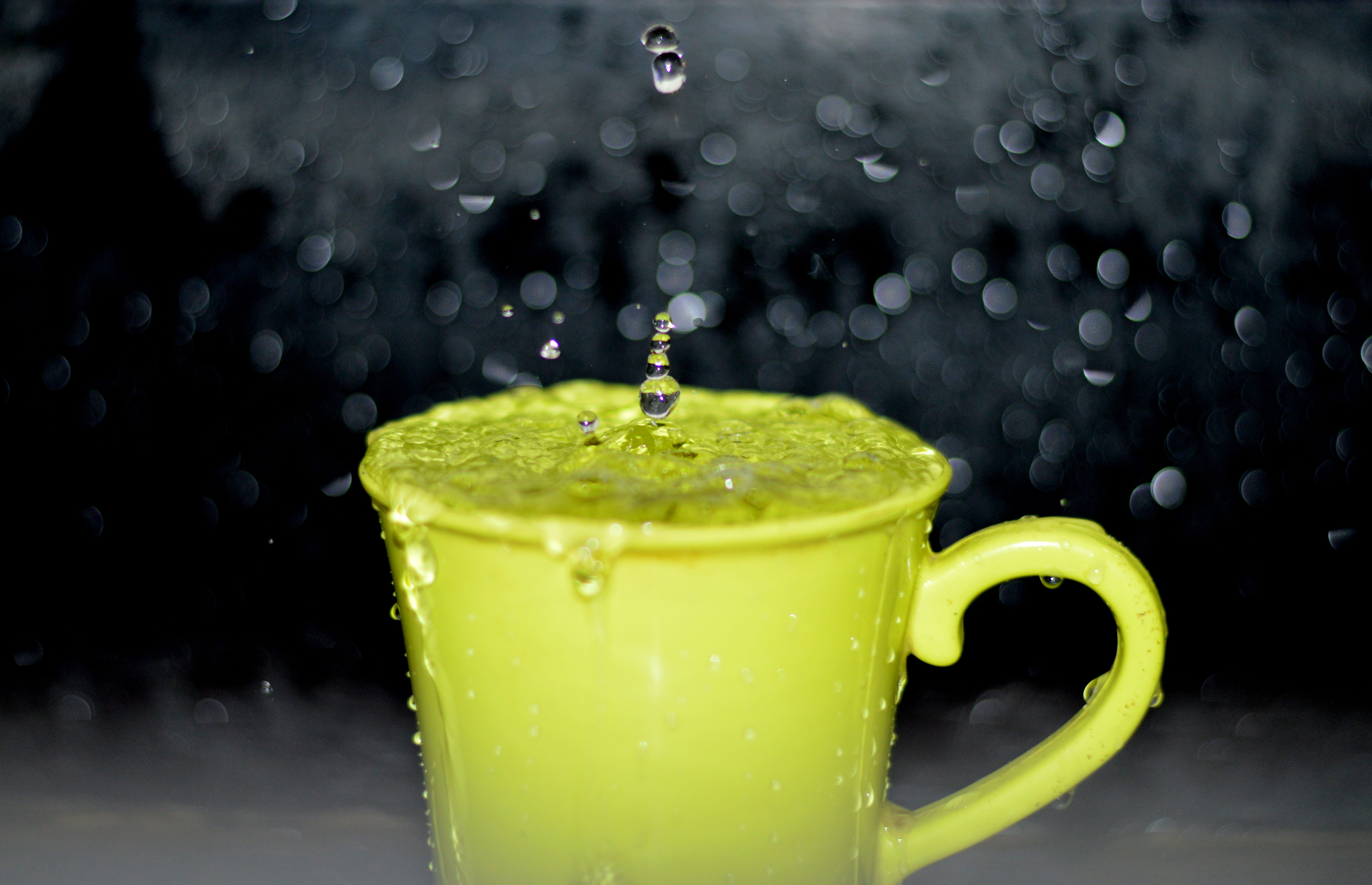 splashing, black background, no people, raindrop, refreshment, ceramic, yellow, photography, splash, 5K, beverage, mug, bokeh, time-lapse, full, cup, focus on foreground, HD Wallpaper