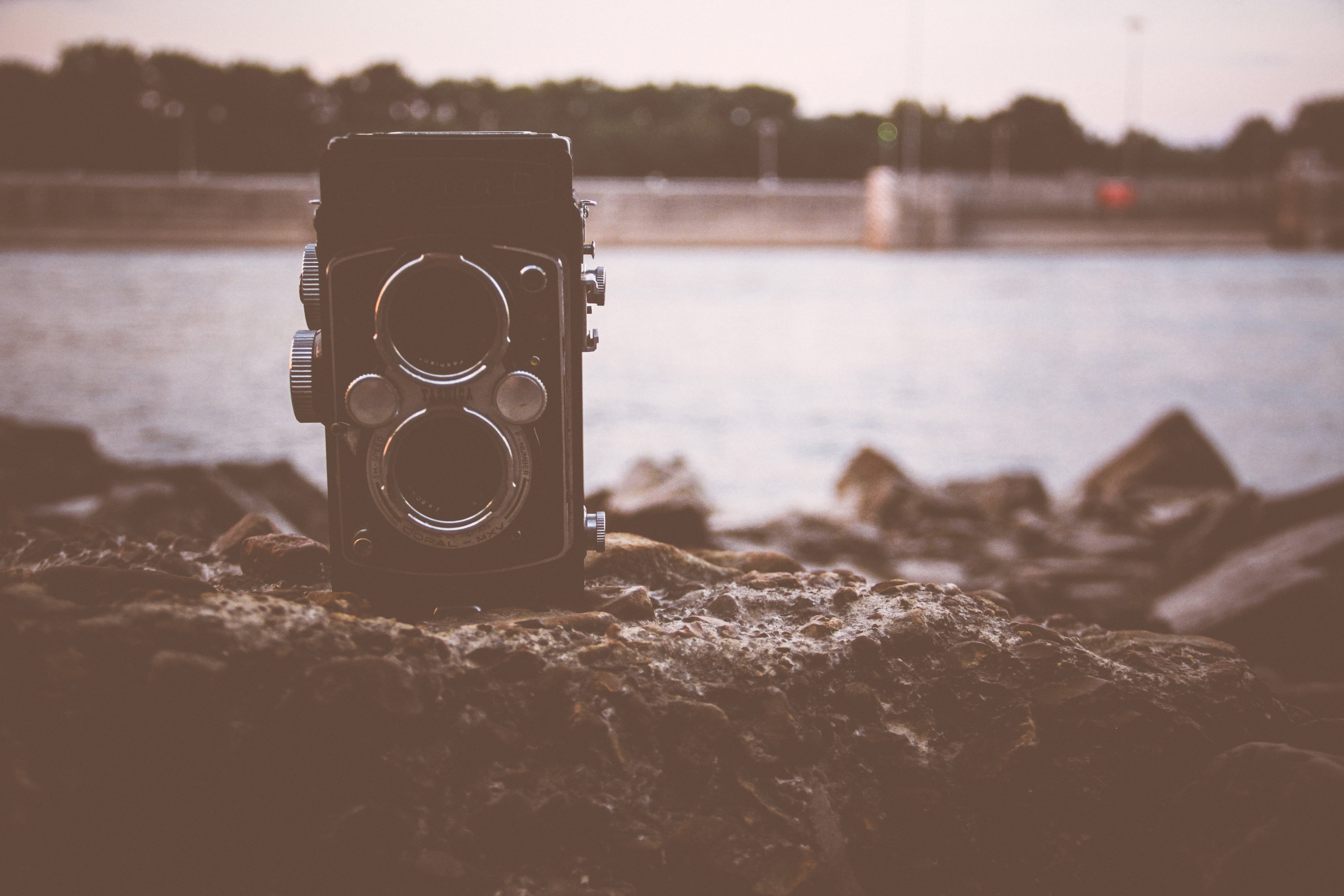 black, rocks, photographic equipment, distance, focus on foreground, photography, focus, yashica, water, 5K, day, rock, lake, digital camera, no people, HD Wallpaper