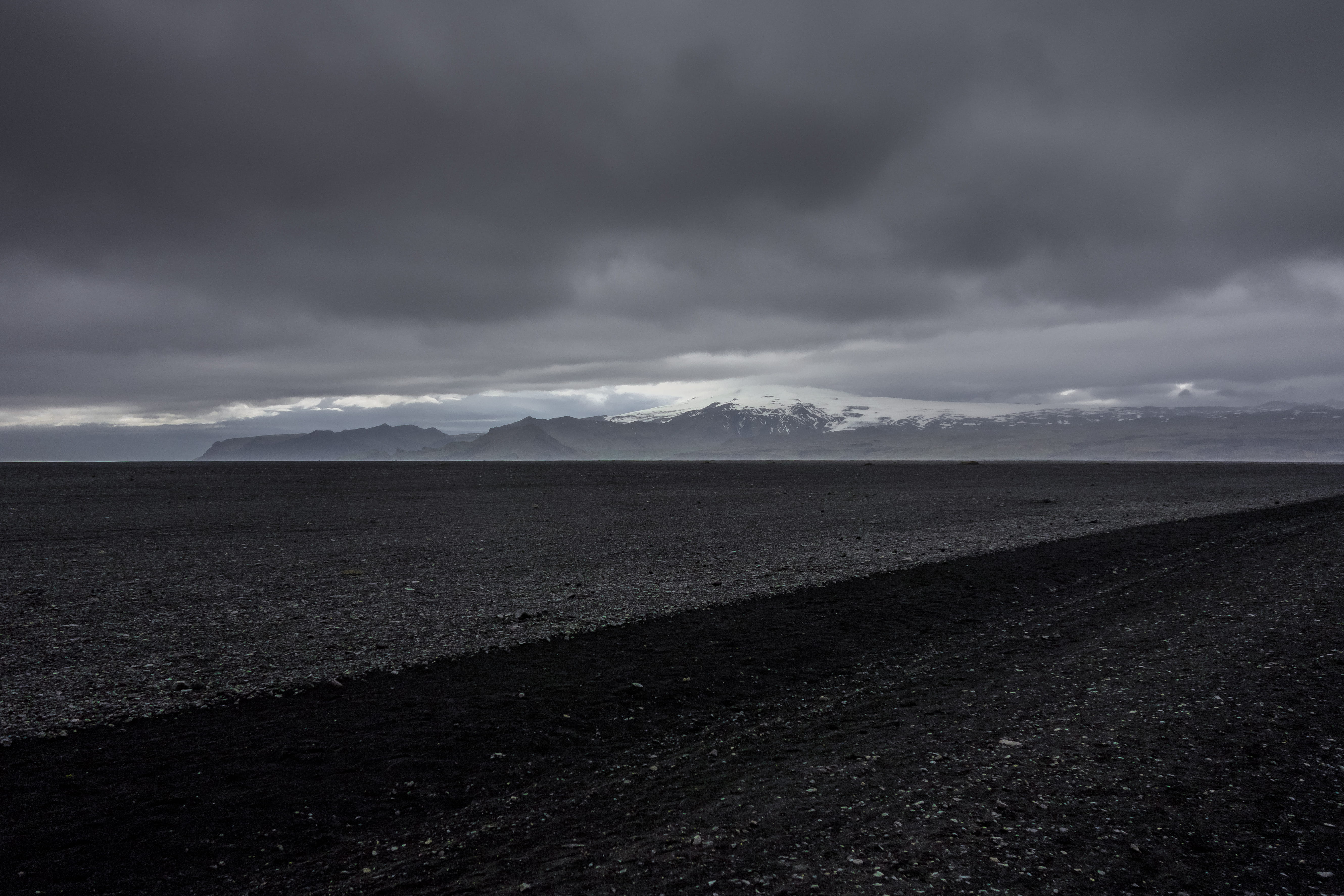 gravel, dark, dirt road, power in nature, tranquility, black sand, nature, solitude, storm, alone, water, sky, solheimasandur, no people, cloudy, rock, HD Wallpaper