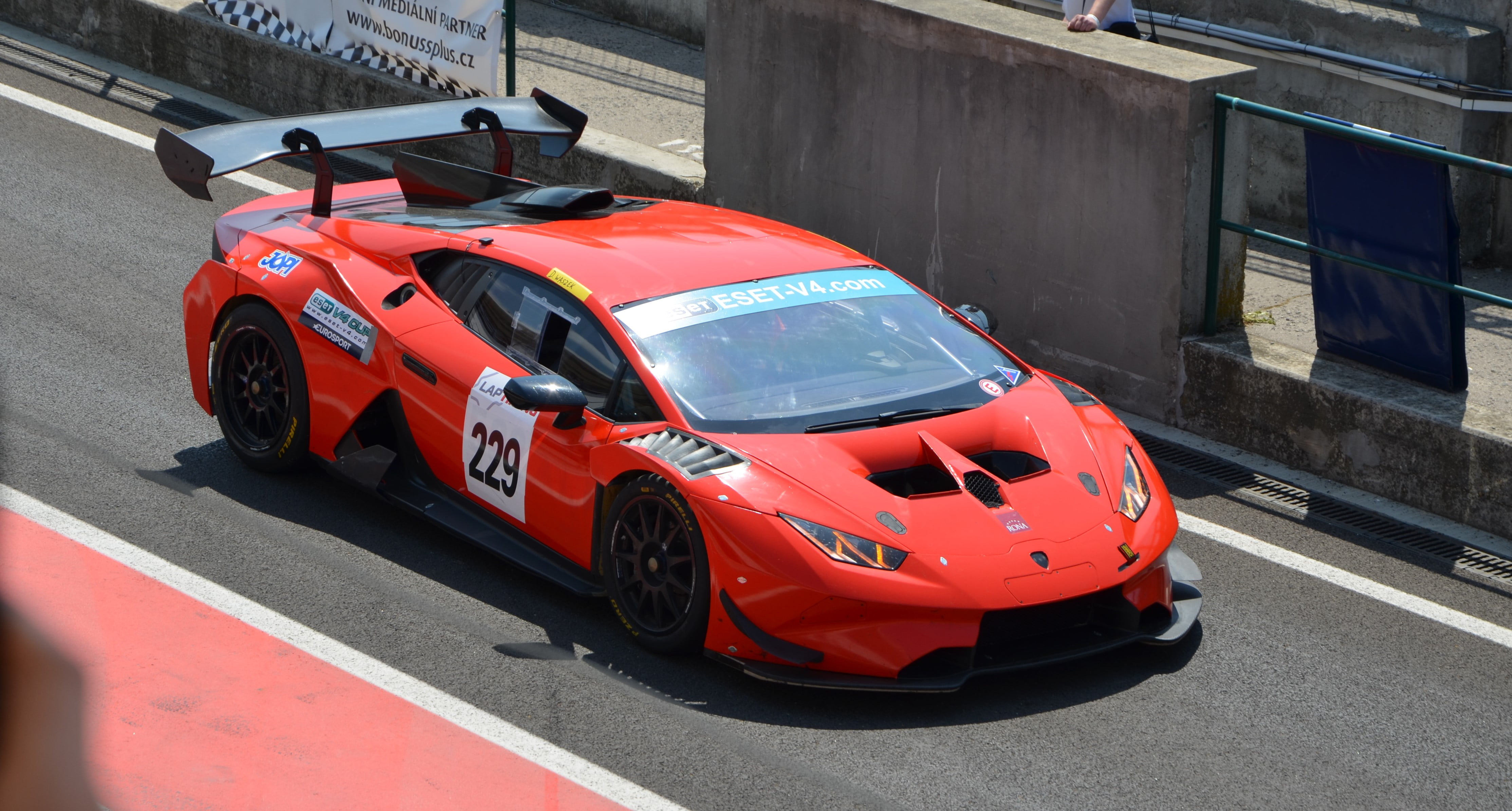 4K, luxury, race cars, Lamborghini Huracan, car, city, architecture, Lamborghini, land vehicle, racecar, day, city life, speed, street, Huracan, red, outdoors, HD Wallpaper