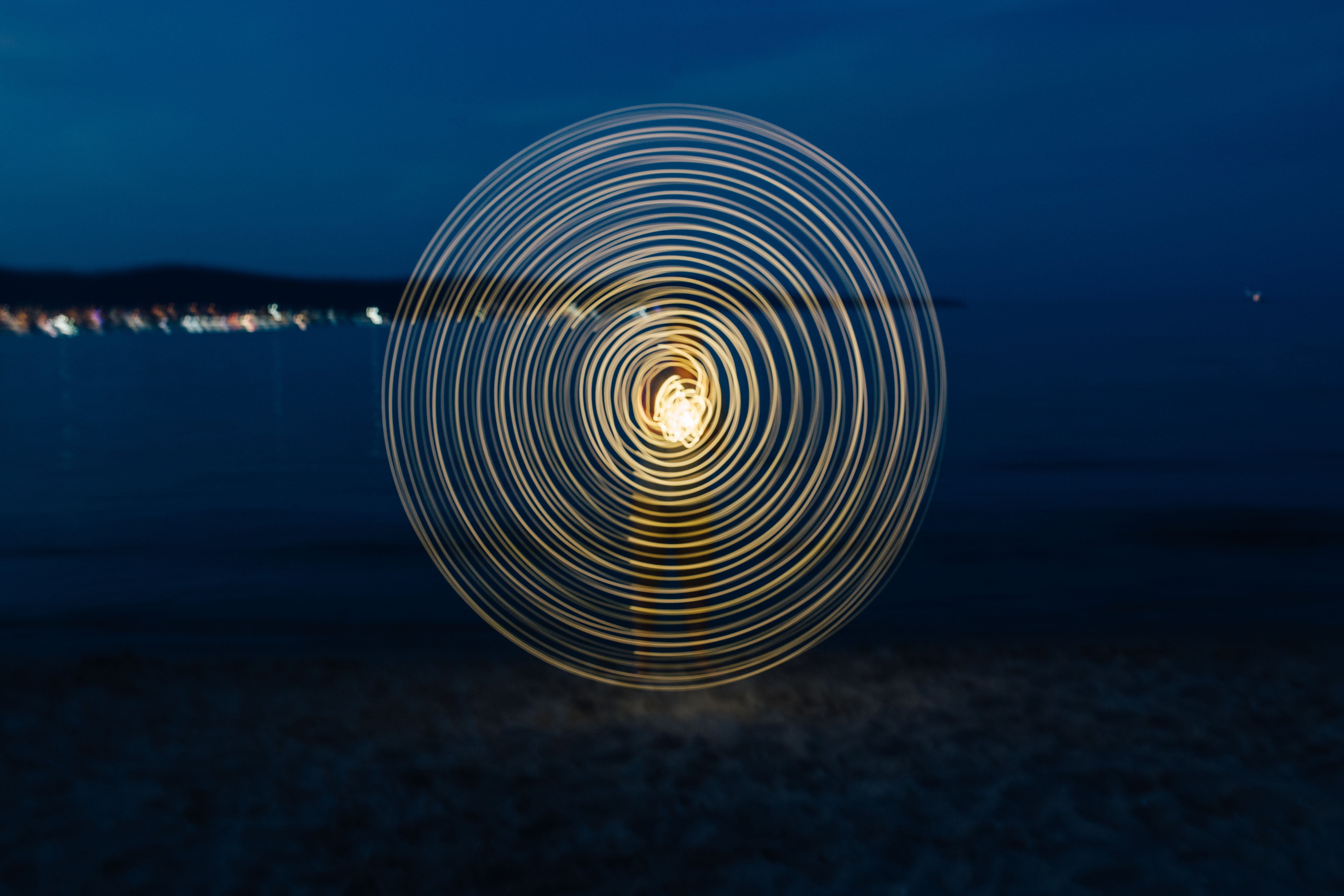 outdoors, painting, spiral, on the beach, 5K, shape, light, spinning, ocean, concentric, reflection, water, dusk, beach, pattern, nigh, sea, wire wool, HD Wallpaper