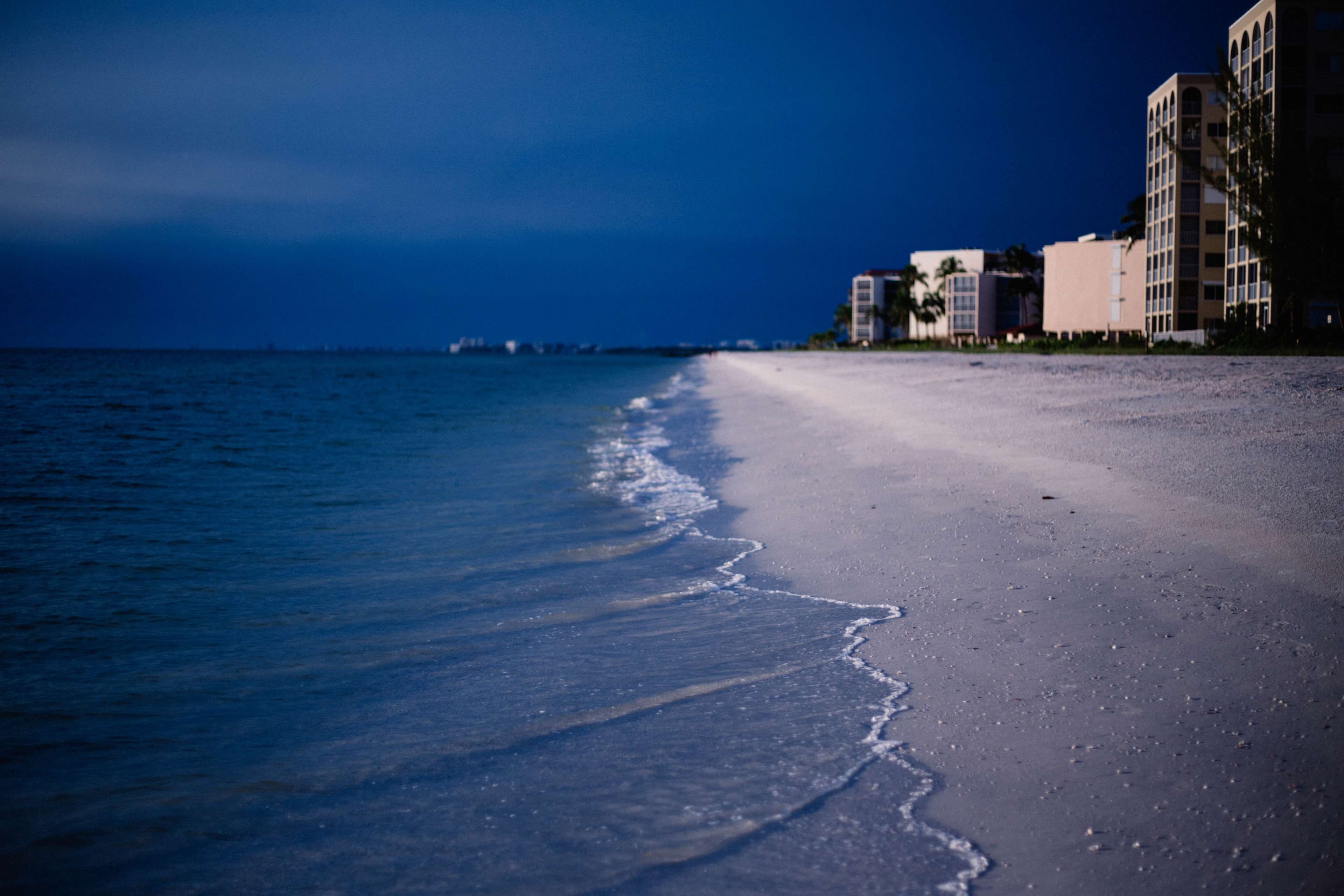 dusk, sky, seashore, motion, land, reflection, coastline, ocean shore, water, resort, beauty in nature, beach, shore, city, light, building exterior, architecture, HD Wallpaper
