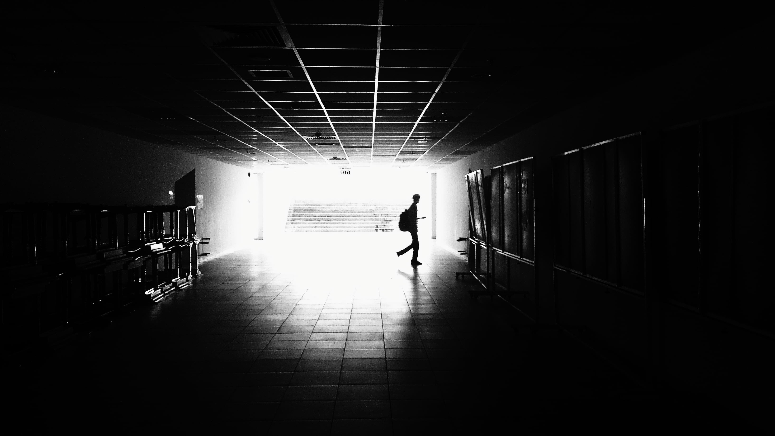 black-and-white, light at the end of the tunnel, urban, day, real people, man, walking, dark, building, 2K, rear view, shadow, ceiling, arcade, direction, HD Wallpaper