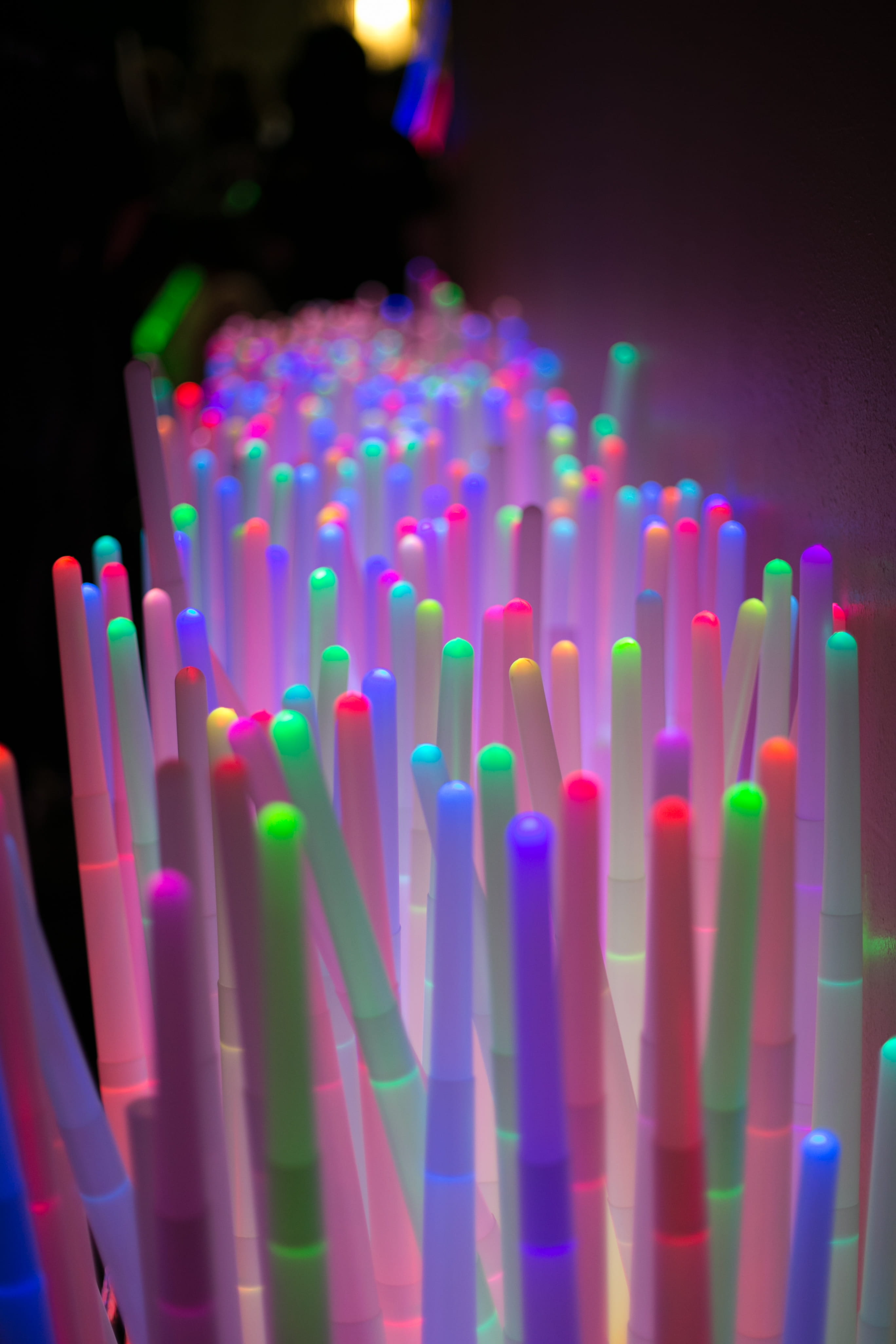 glowing, 4K, illuminated, abstract, glow sticks, neon colors, selective focus, multi colored, neon, indoors, studio shot, focus on foreground, no people, Phone HD Wallpaper
