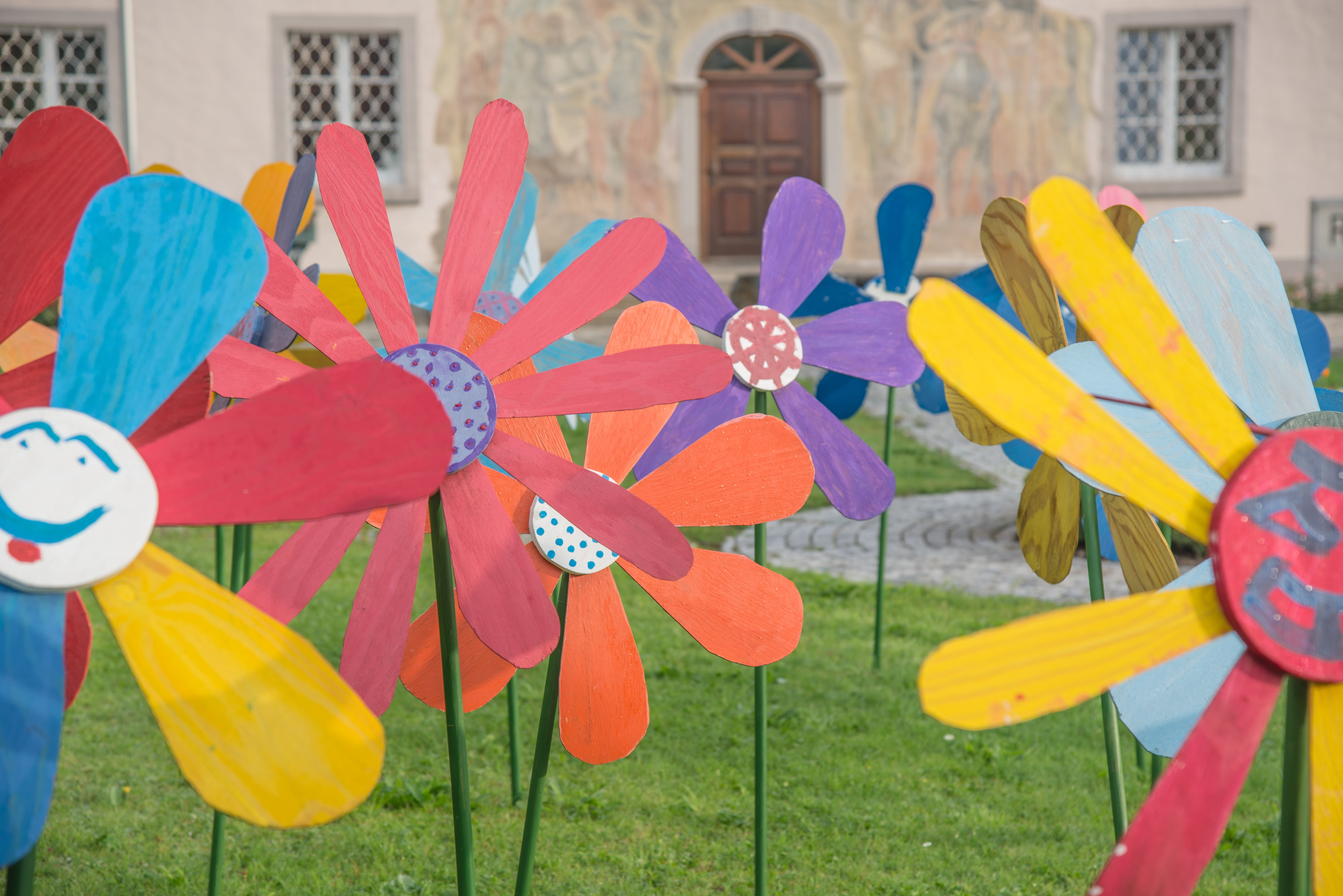front yard, wooden flowers, flower, day, art, building exterior, yellow, large group of objects, 5K, no people, red, architecture, garden, multi colored, HD Wallpaper