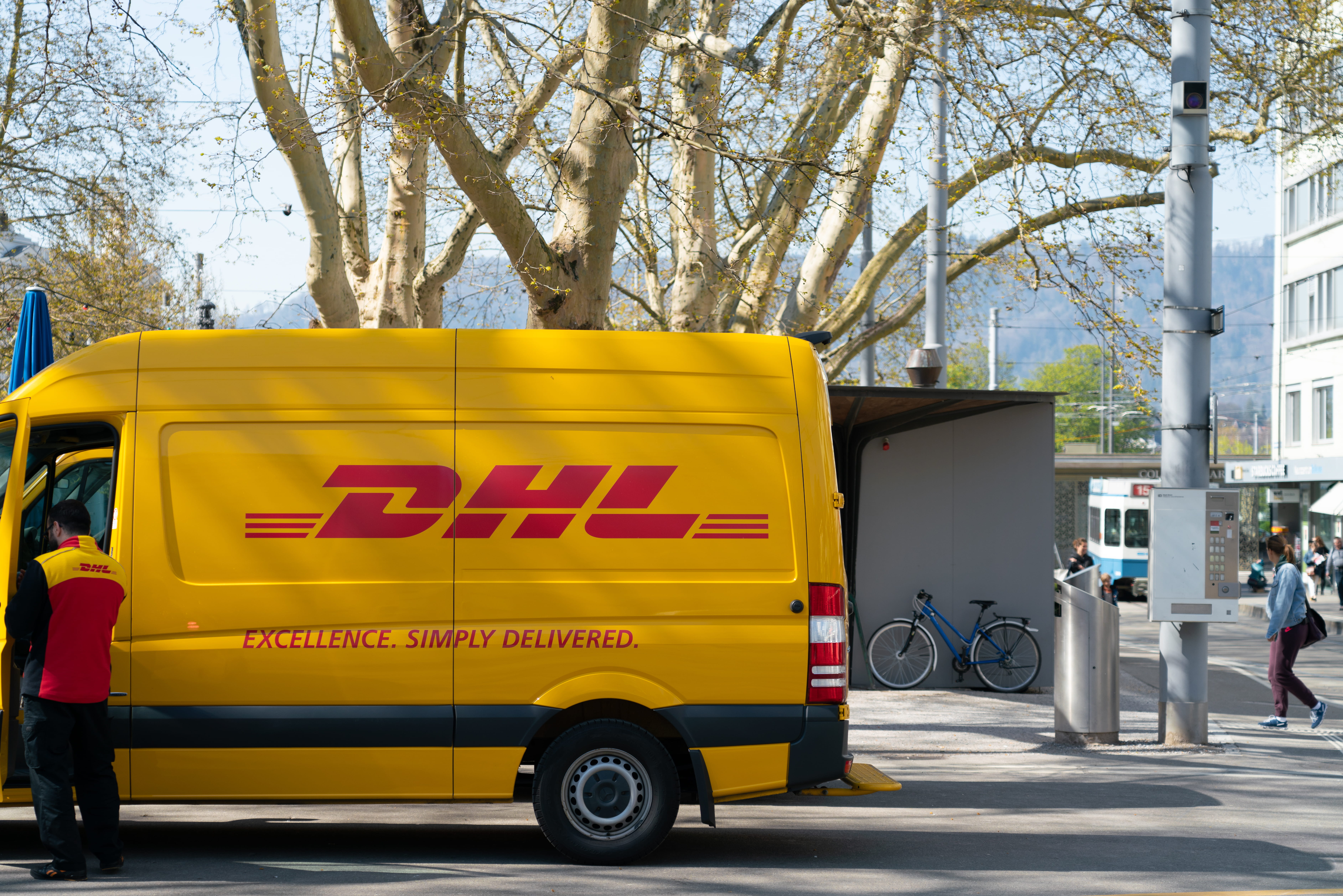 people, real people, sign, occupation, land vehicle, architecture, standing, mode of transportation, dhl, city, road, motor vehicle, plant, text, day, front, HD Wallpaper
