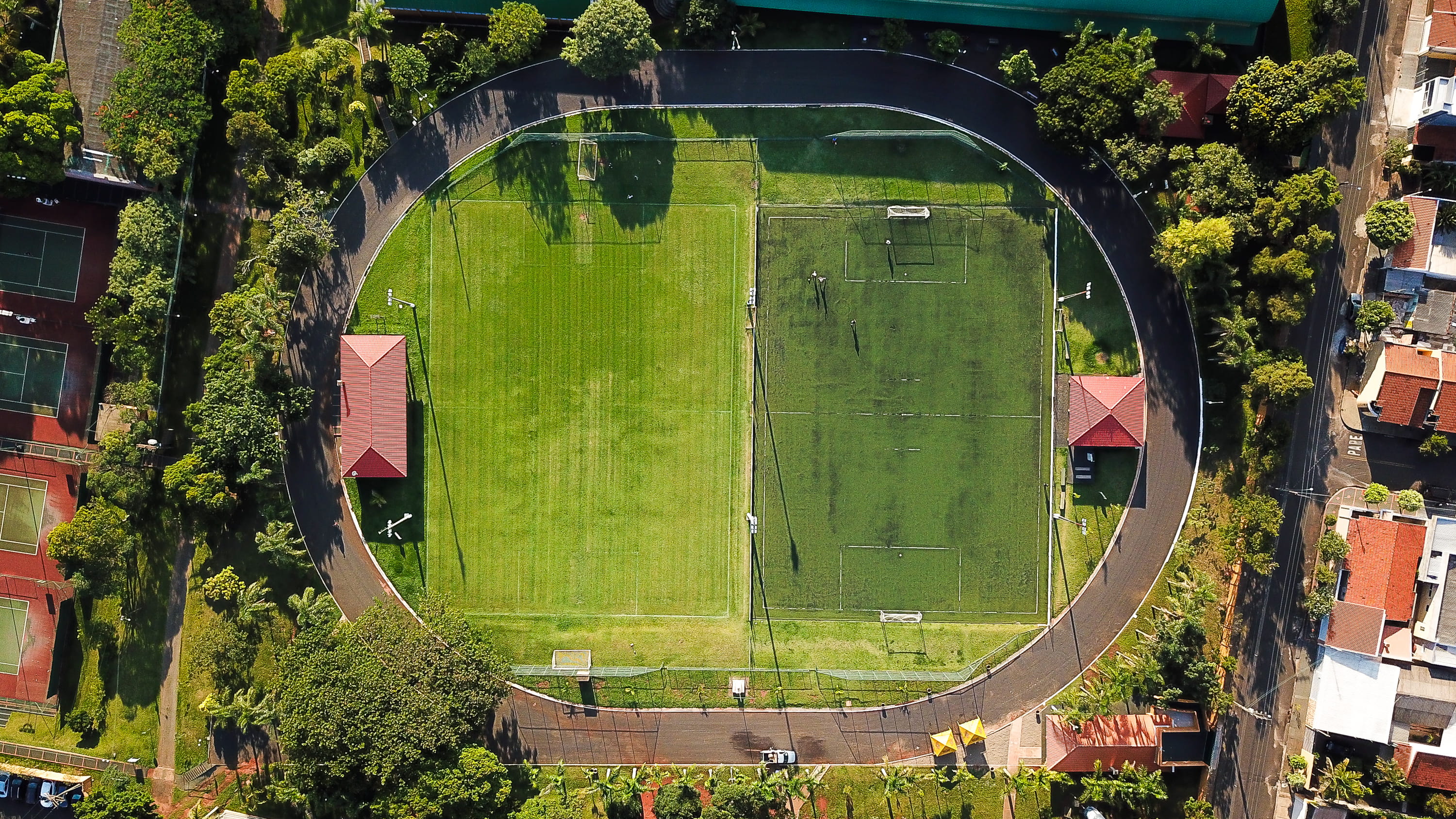 campus, team sport, outdoors, no people, arena, building, tranquility, day, sunlight, field, plant, football field, daytime, park, 2K, grass, green, angle, HD Wallpaper