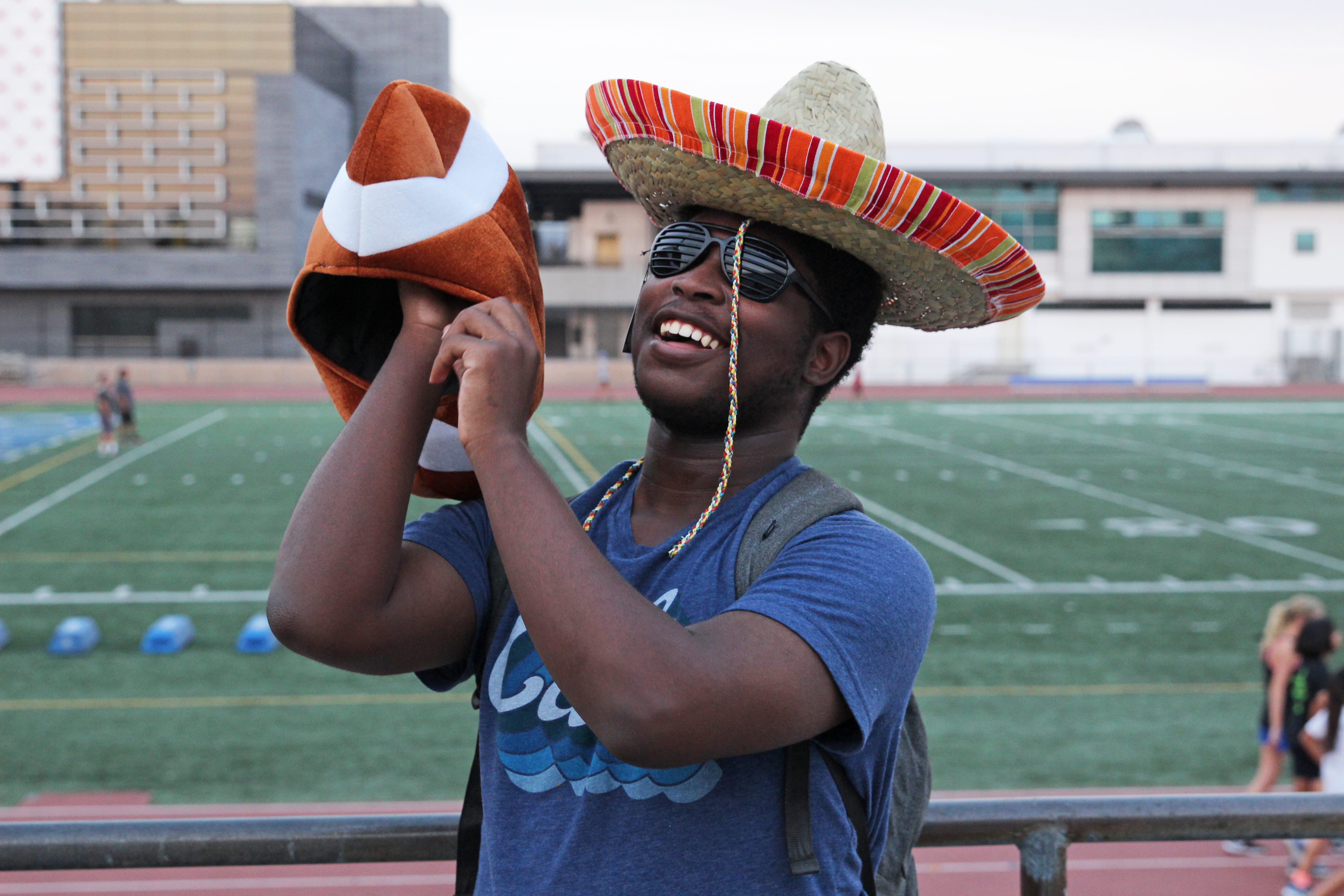 incidental people, silly, outdoors, obscured face, adult, waist up, black guy, one person, holding, beside, photography, football, man, front view, real people, HD Wallpaper