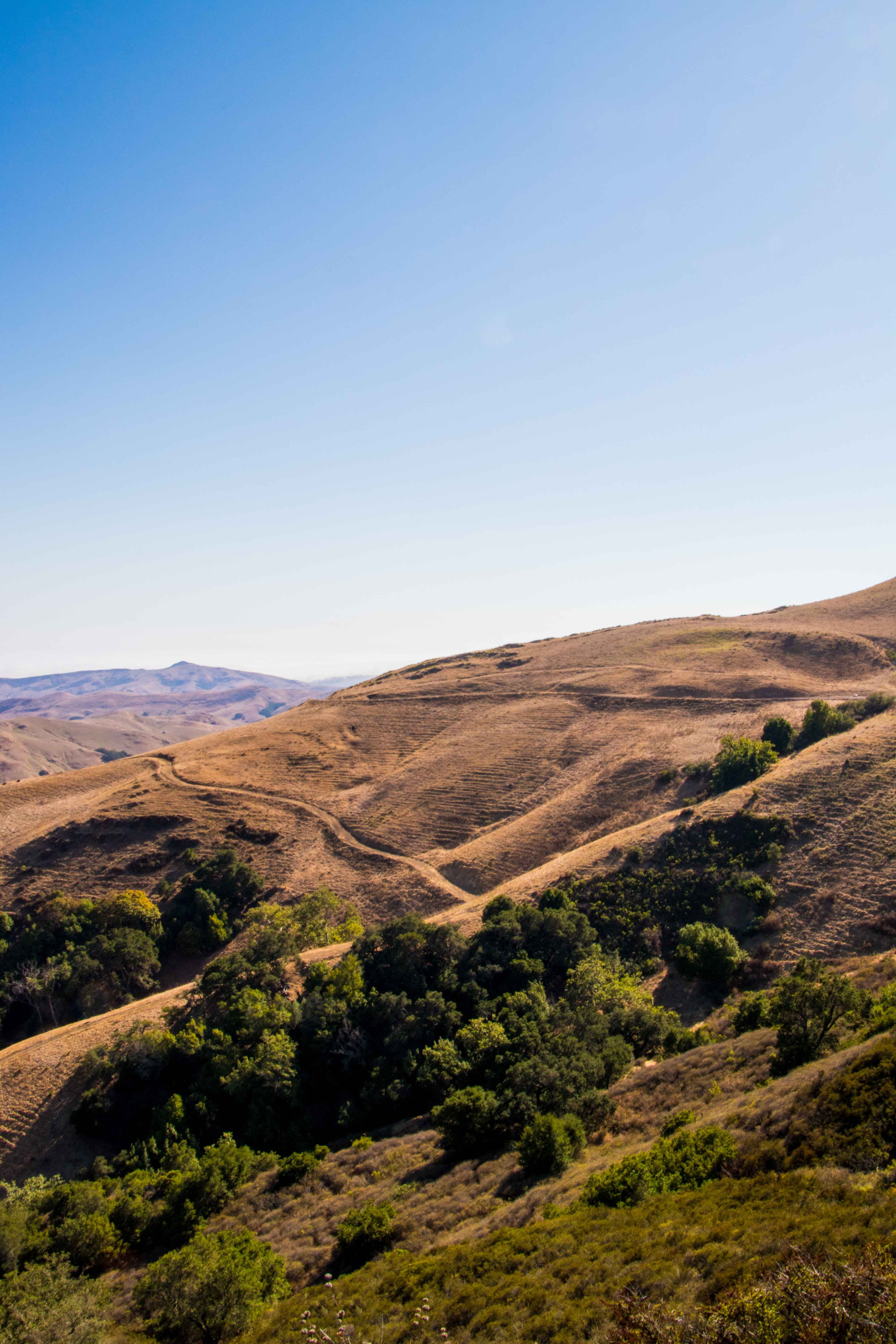 west coast, overview, land, mountains, america, view, tranquil scene, mountain, asphalt, sunny, 5K, non-urban scene, blue, clear sky, hilly, desert, outlook, Phone HD Wallpaper