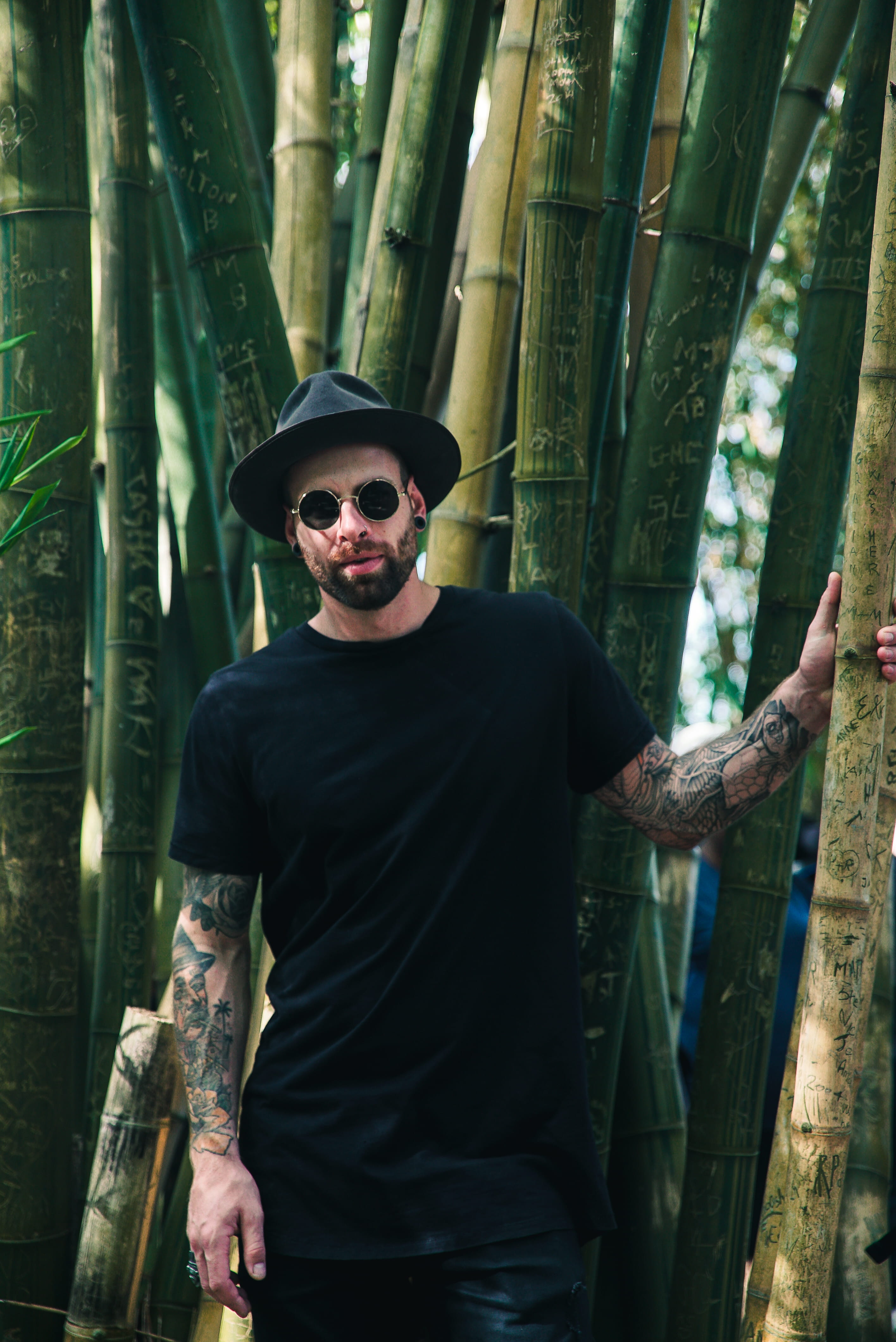 handsome, sunglasses, real people, wear, tree, bamboo, portrait, wearing, man, adult, plant, holding, front view, tattoo, hat, glasses, men, 4K, young adult, Phone HD Wallpaper